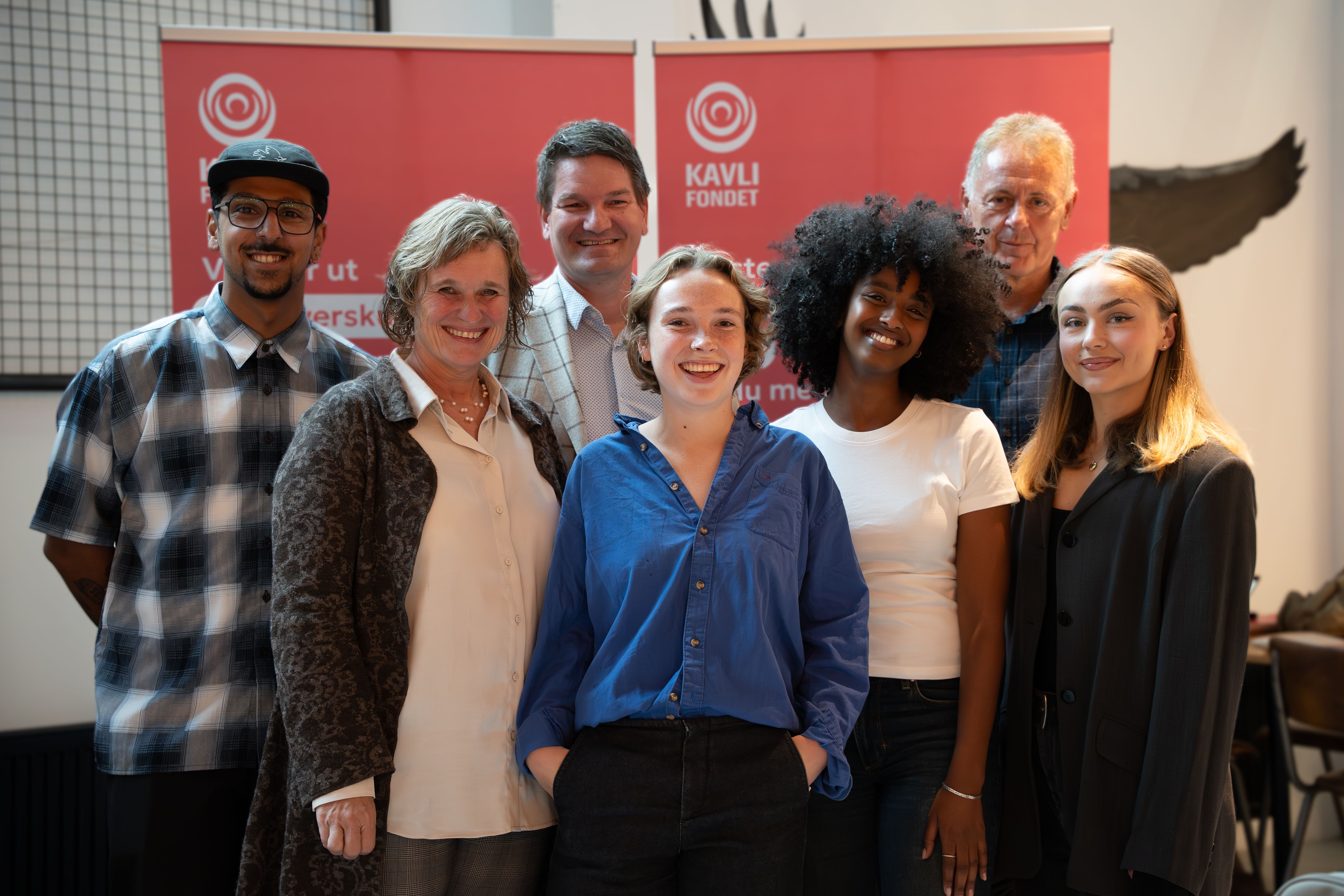 A group of young people stand together indoors, smiling at the camera. The image shows participants in Young Citizenship and represents engagement, diversity and democratic participation.