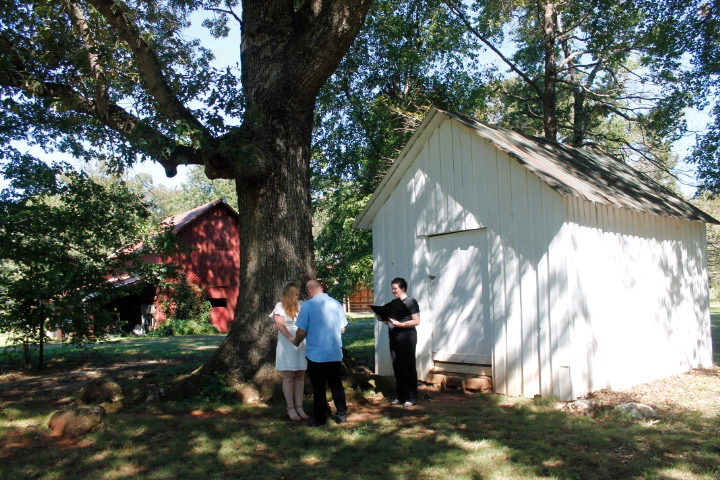 Sonya, Kevin, and Carly at Windy Hill Farm, a large tree and barn in the background