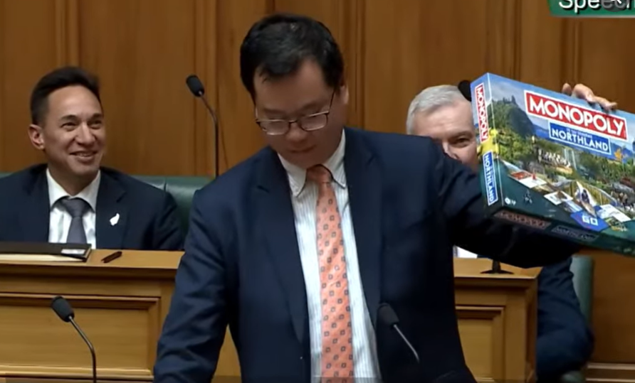 Carlos Cheung holding up Monopoly board game