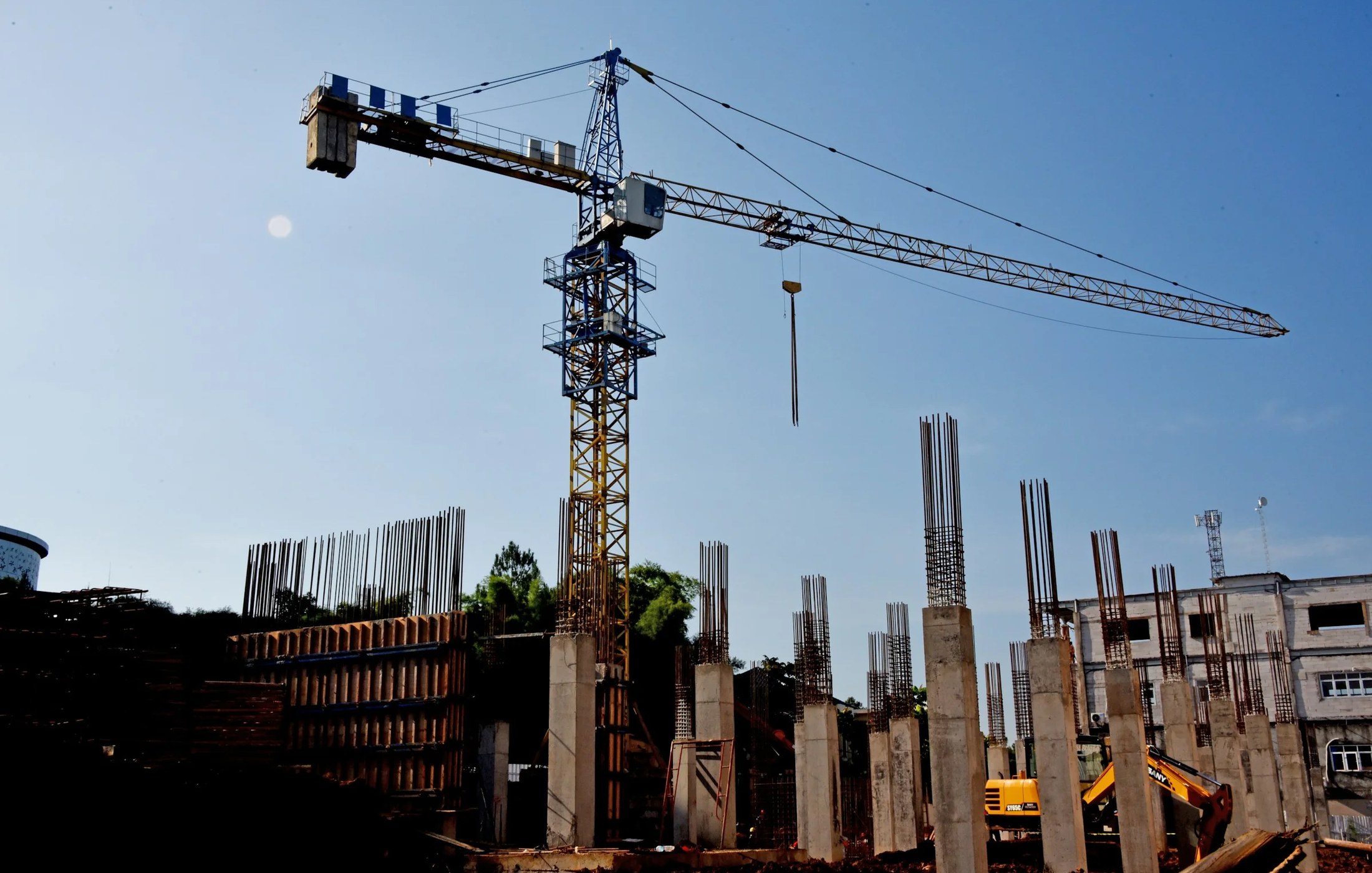 Tower crane working above concrete columns at an active construction site