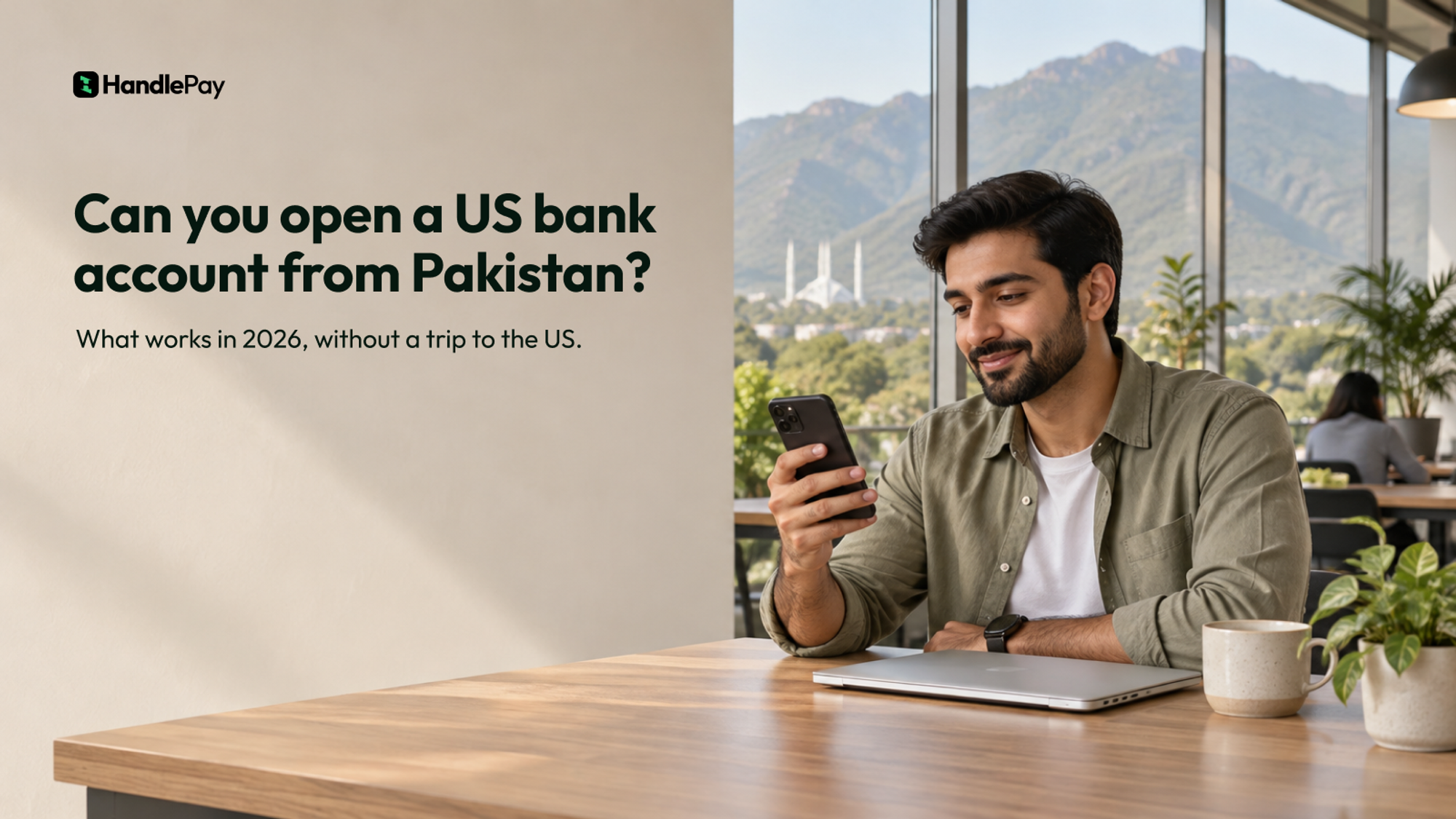A Pakistani man smiling at his phone in a bright Islamabad co-working space, with the Margalla Hills and Faisal Mosque behind him, and the headline Can you open a US bank account from Pakistan?