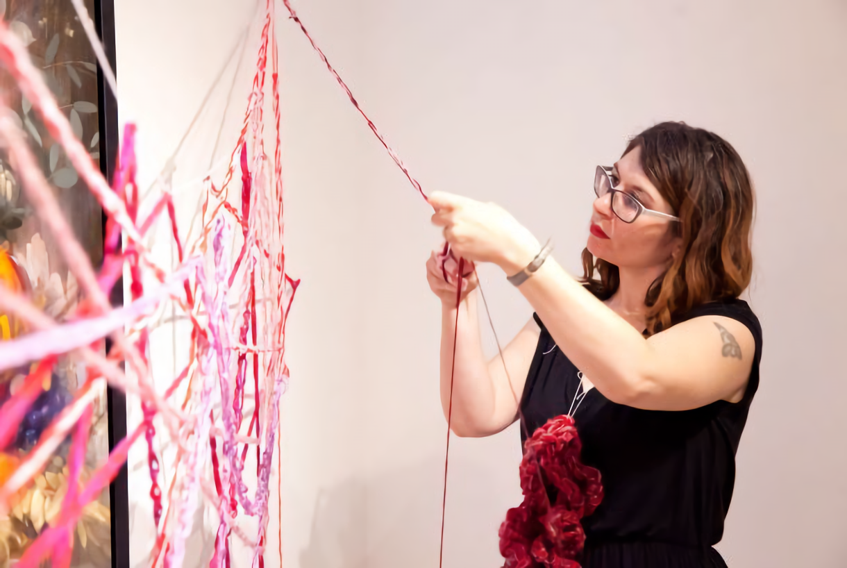 the artist Barbara Touati-Evans handcrocheting a web