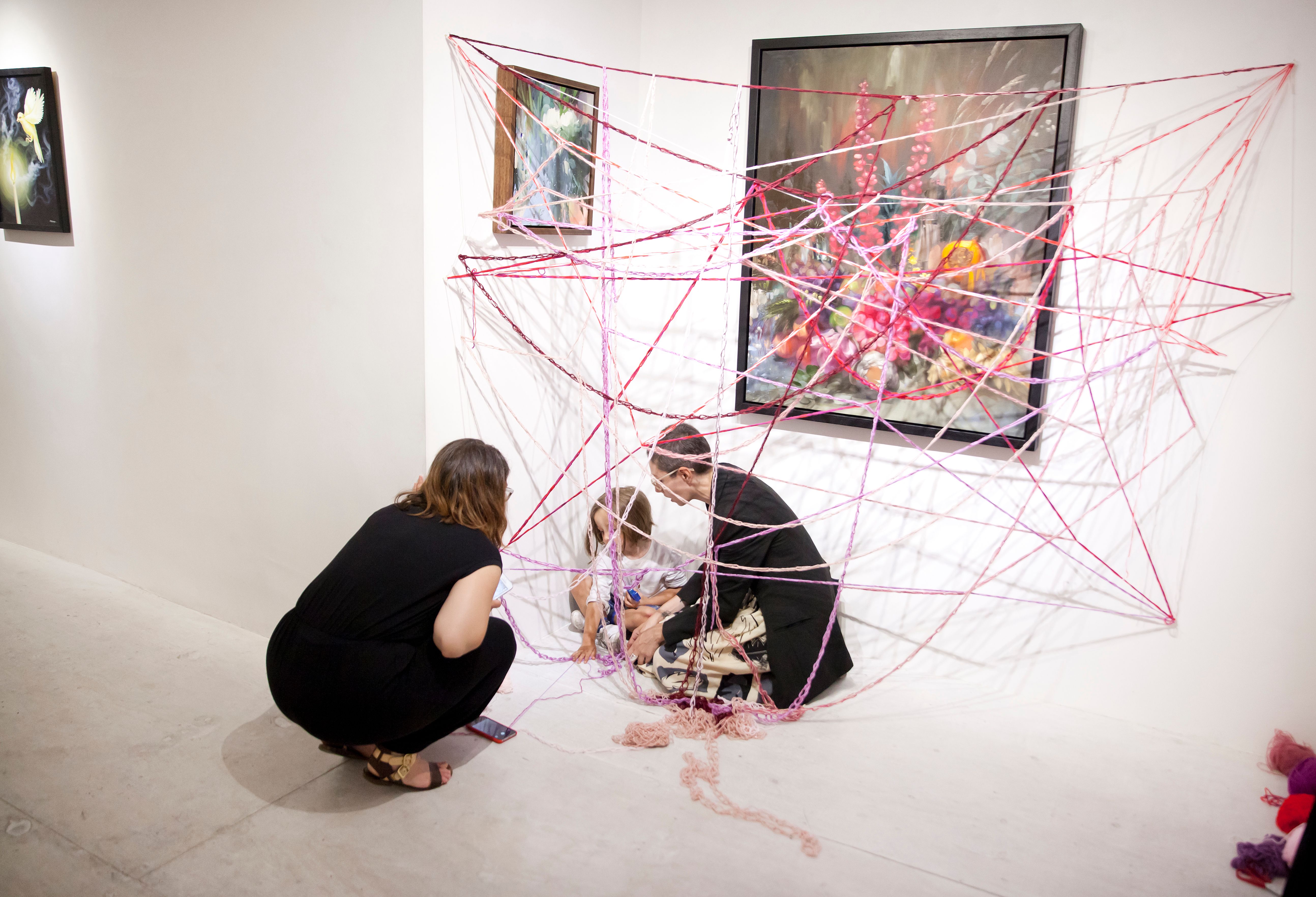 The artist Barbara Touati-Evans observing how members of the public interact with her installation