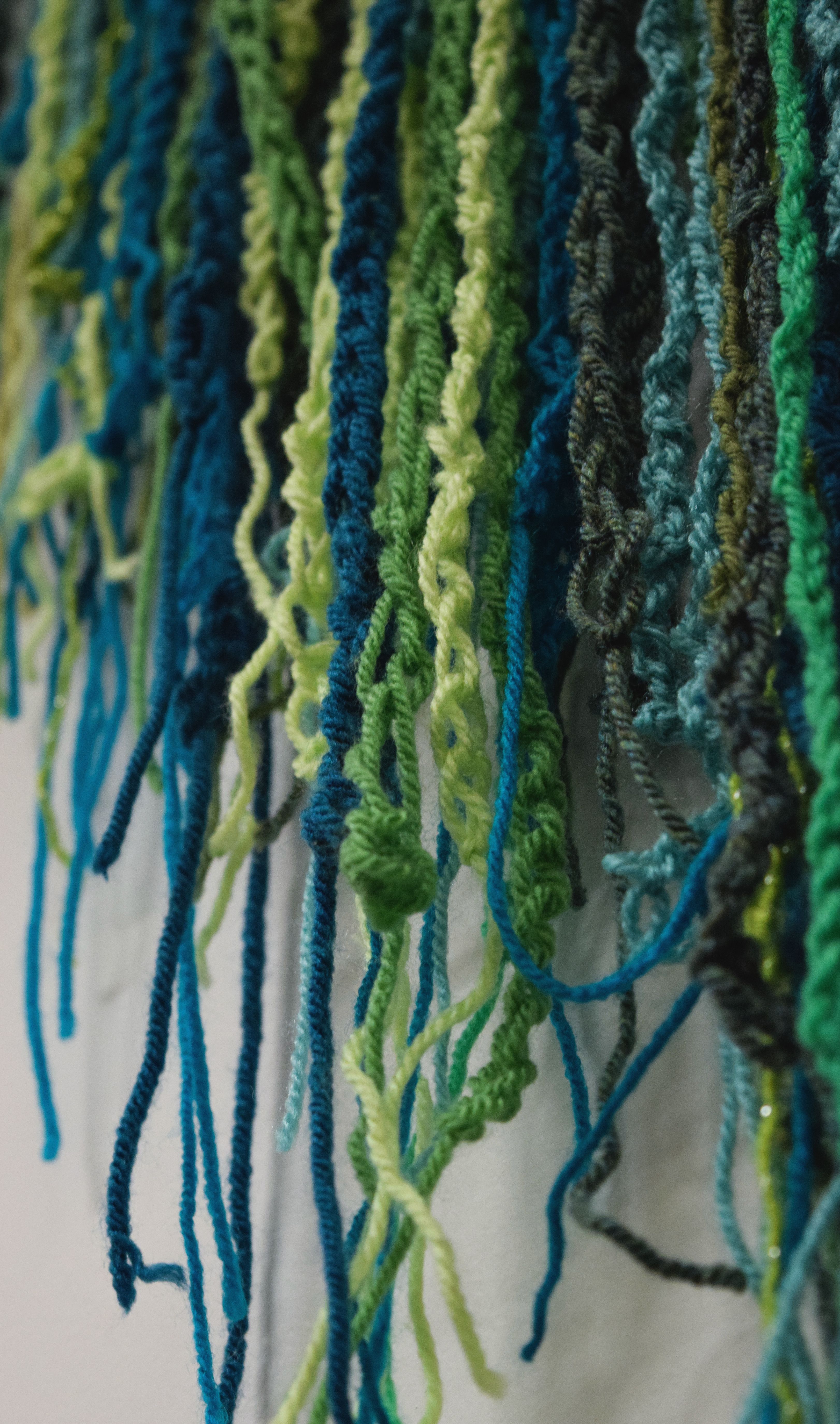 A close up of green crochet chains