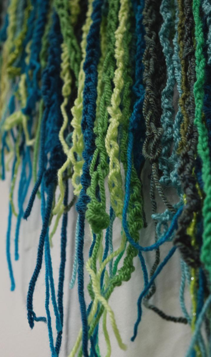 A close up of green crochet chains