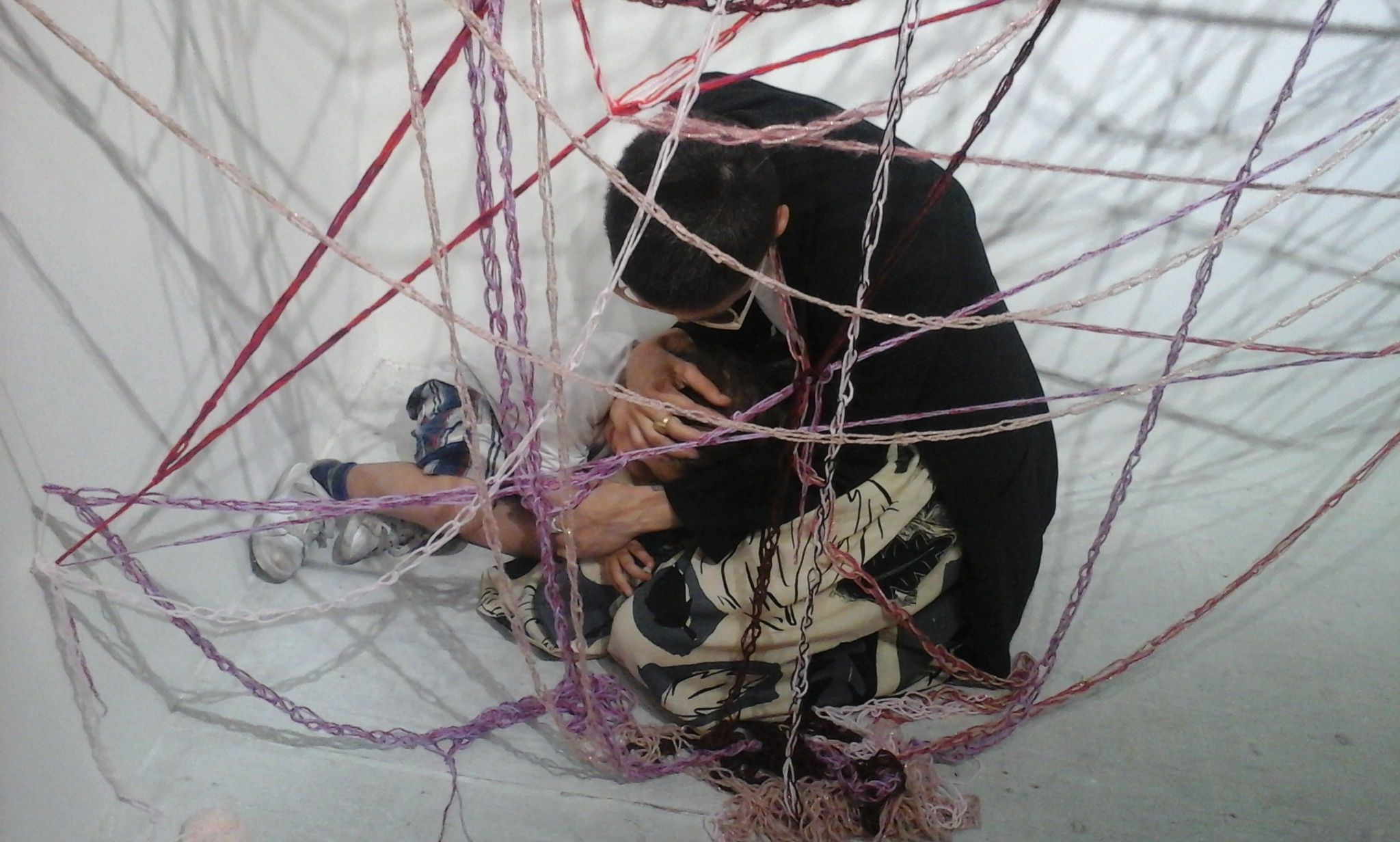 A mother and child interacting with the installation Webwomb