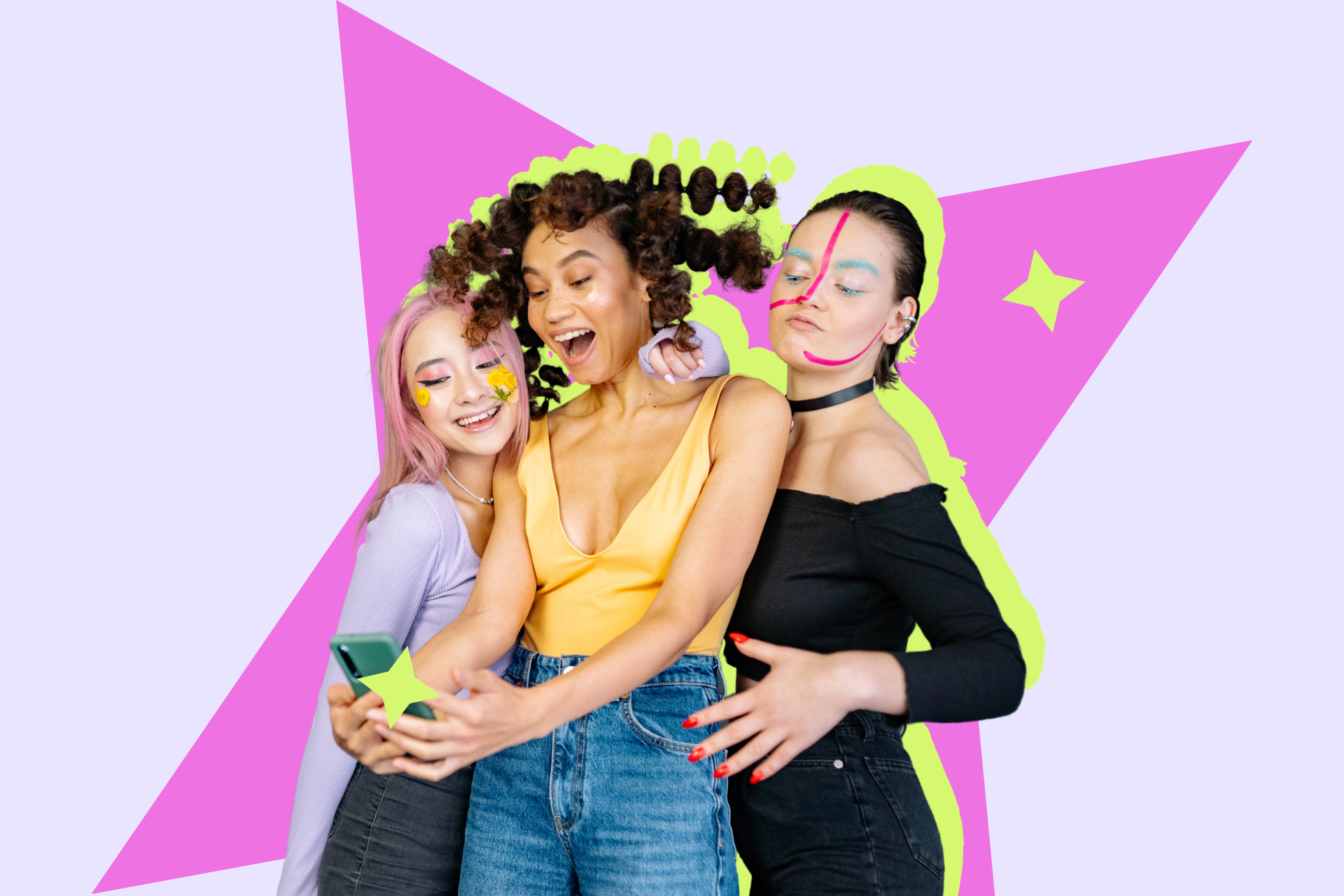 Three young women with colourful makeup taking a selfie together against a bright graphic backdrop.