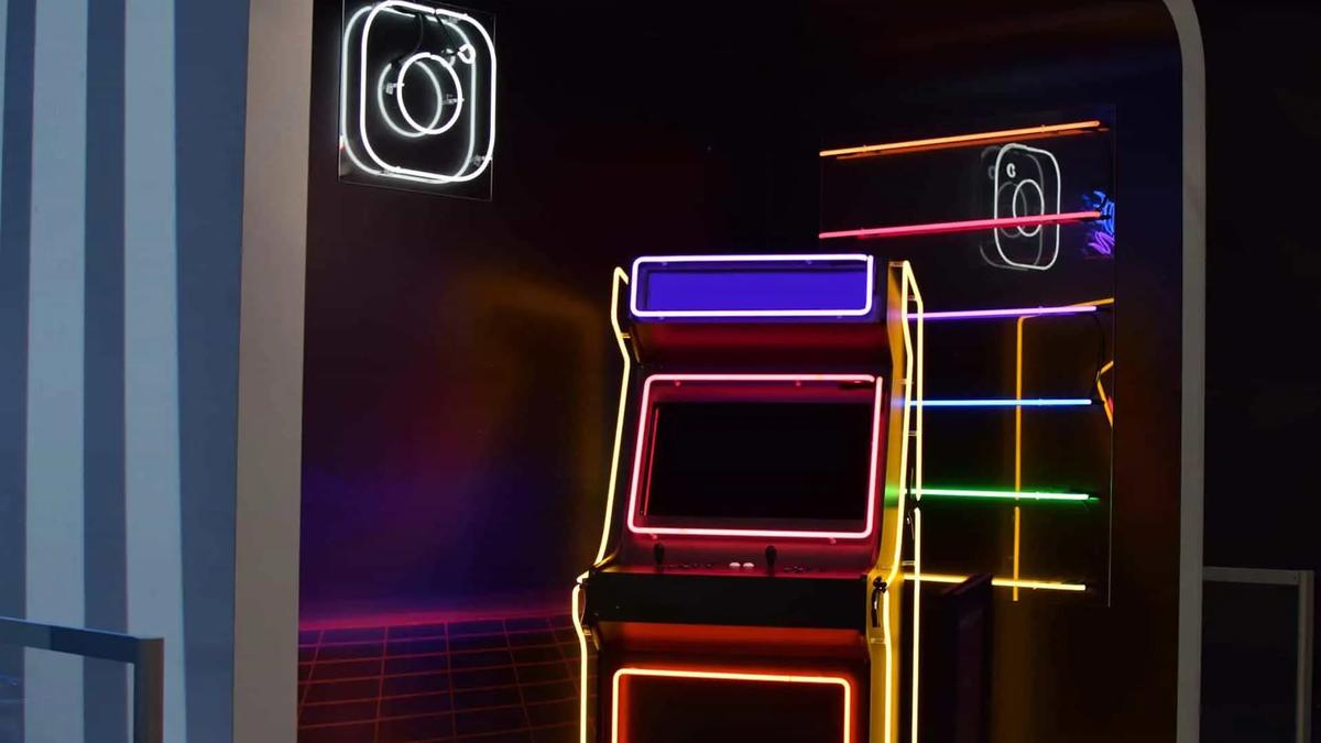 A neon-lit arcade cabinet beside a glowing Instagram logo sign on a dark wall
