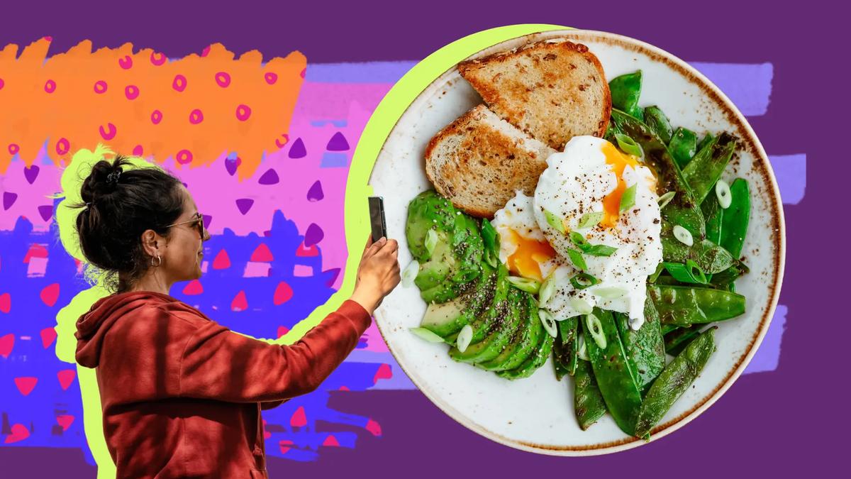 Person in red hoodie taking a photo of a plate with avocado, poached eggs, toast, and green beans. Purple background with colorful abstract shapes.