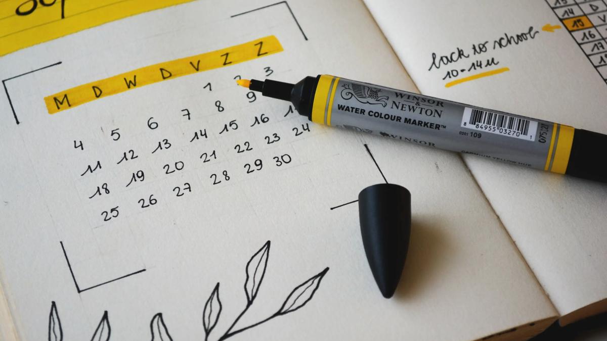 Open planner with 'September' calendar, a yellow 'Winsor Newton Water Colour Marker', and 'back to school' text.