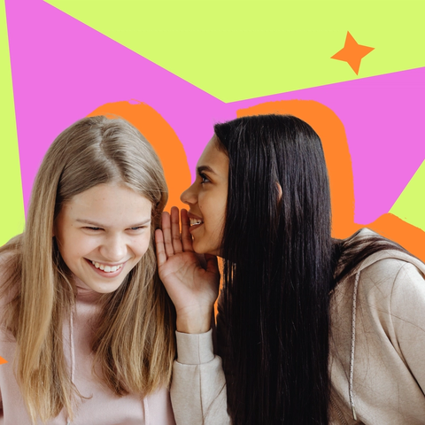 Two young women in pastel hoodies, one leaning in to whisper to the other against a bright graphic backdrop.