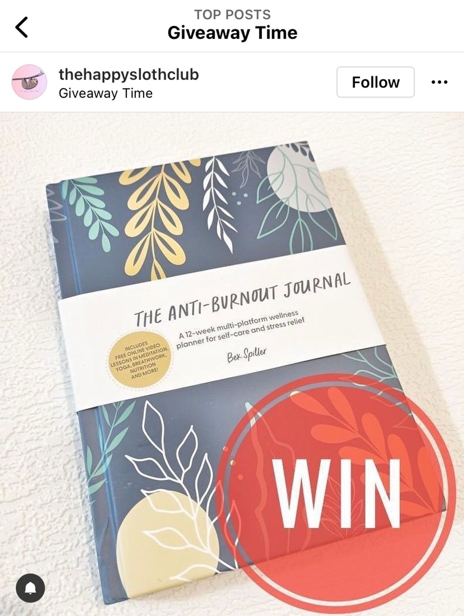 Instagram giveaway post from thehappyslothclub featuring The Anti-Burnout Journal and a red WIN badge.