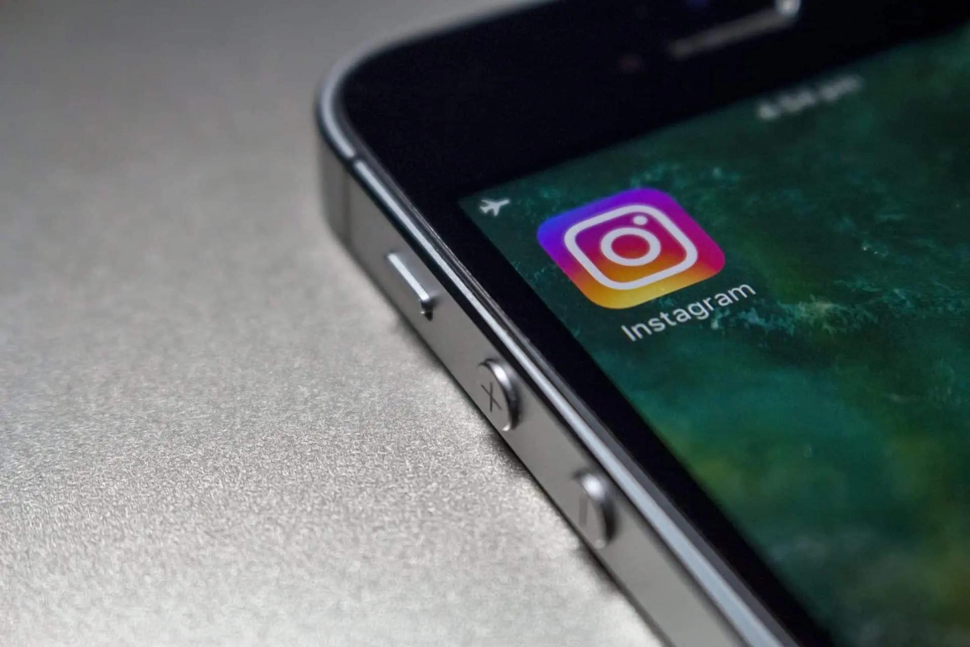 Close-up of a smartphone edge showing the Instagram app icon on the home screen