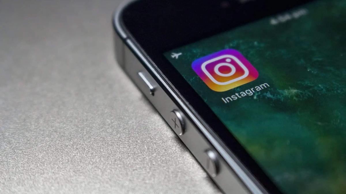 Close-up of a smartphone edge showing the Instagram app icon on the home screen