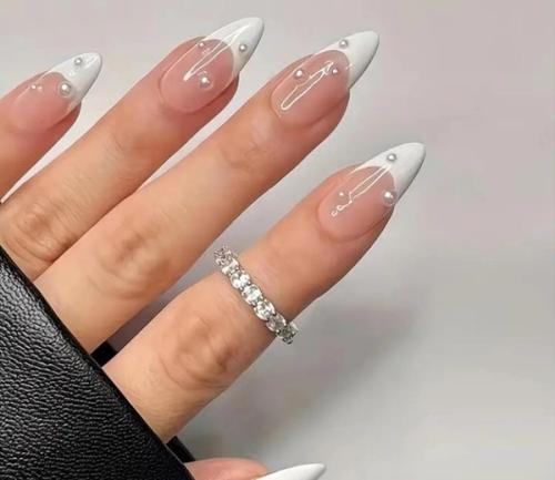 Medium-Length White-Edged Pearl Nails.