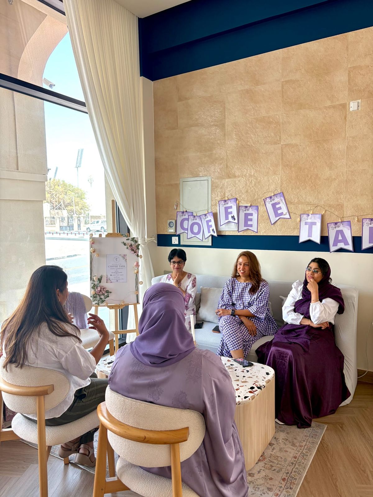 Women gathered in conversation at a Coffee Talk women's circle