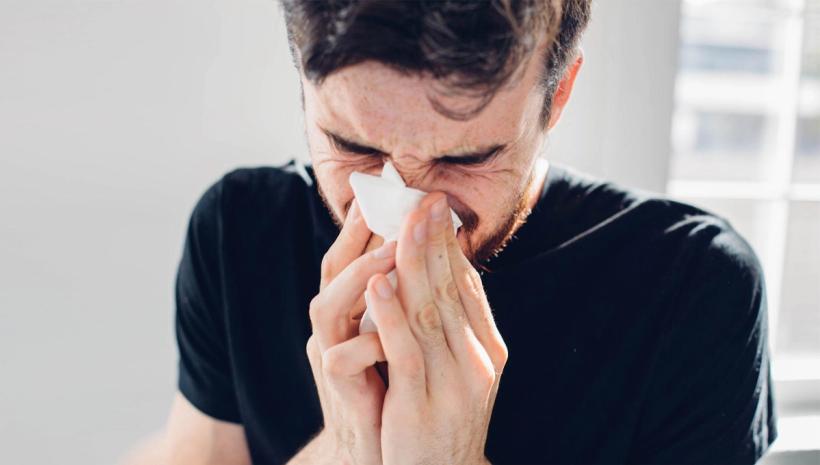 Man blowing his nose