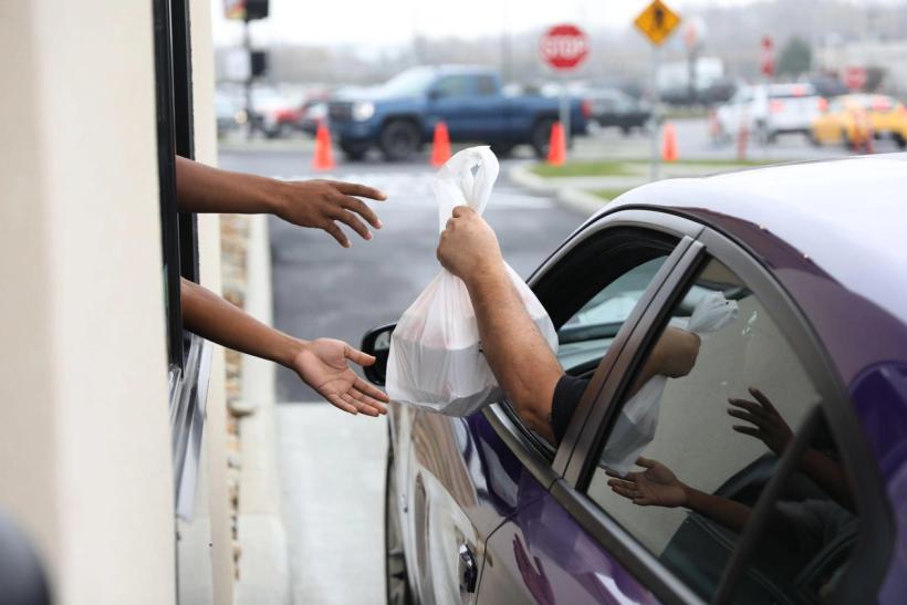 Someone ordering fast food at a drive through