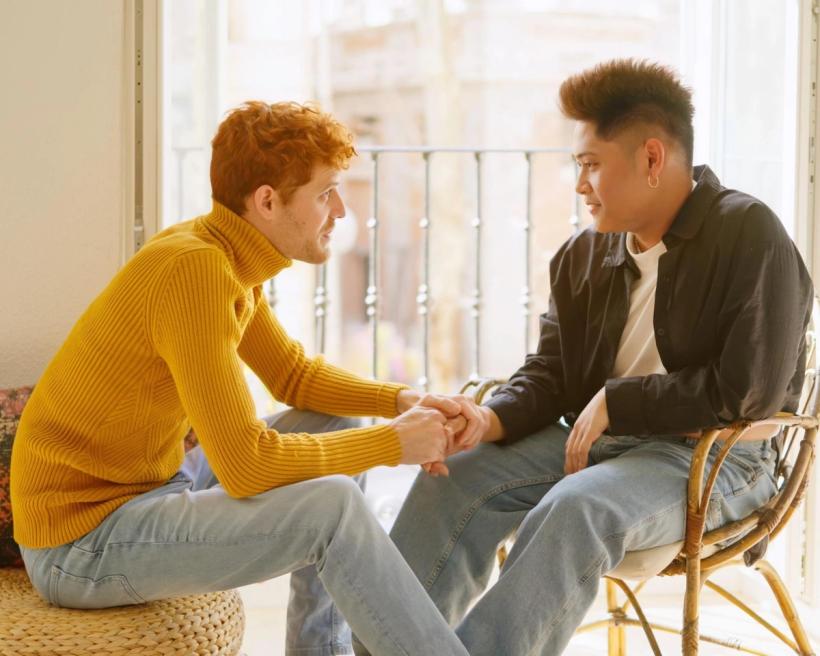 A couple holding hands having a serious conversation