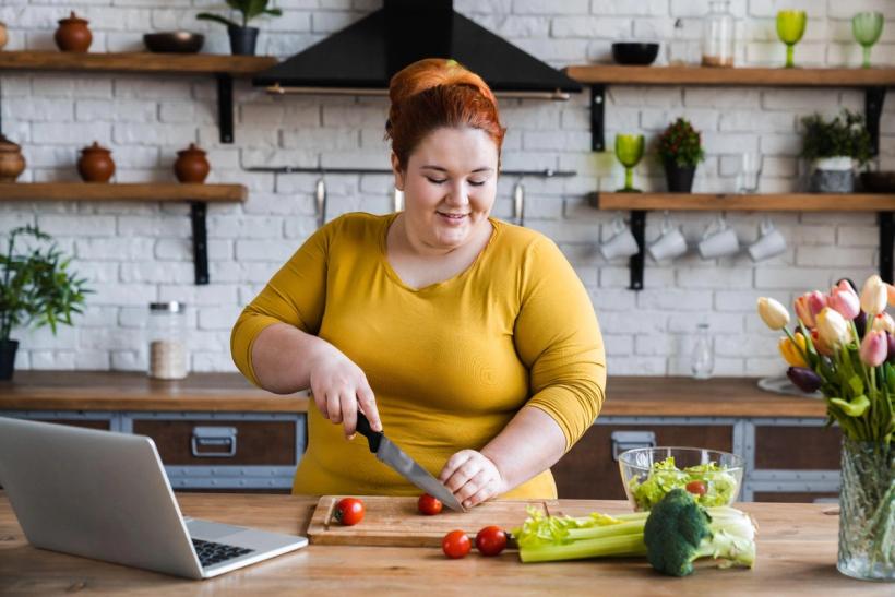 Woman cooking a meal to boost GLP-1 naturally