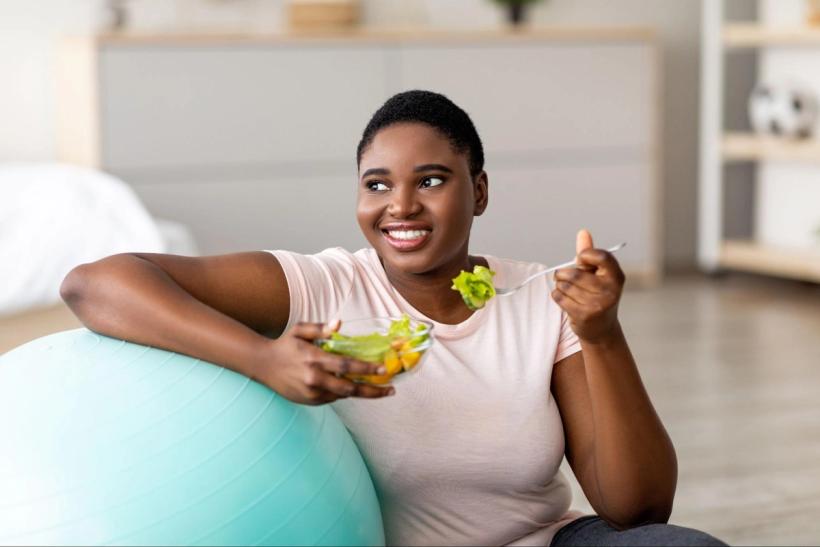 A woman eating a healthy salad