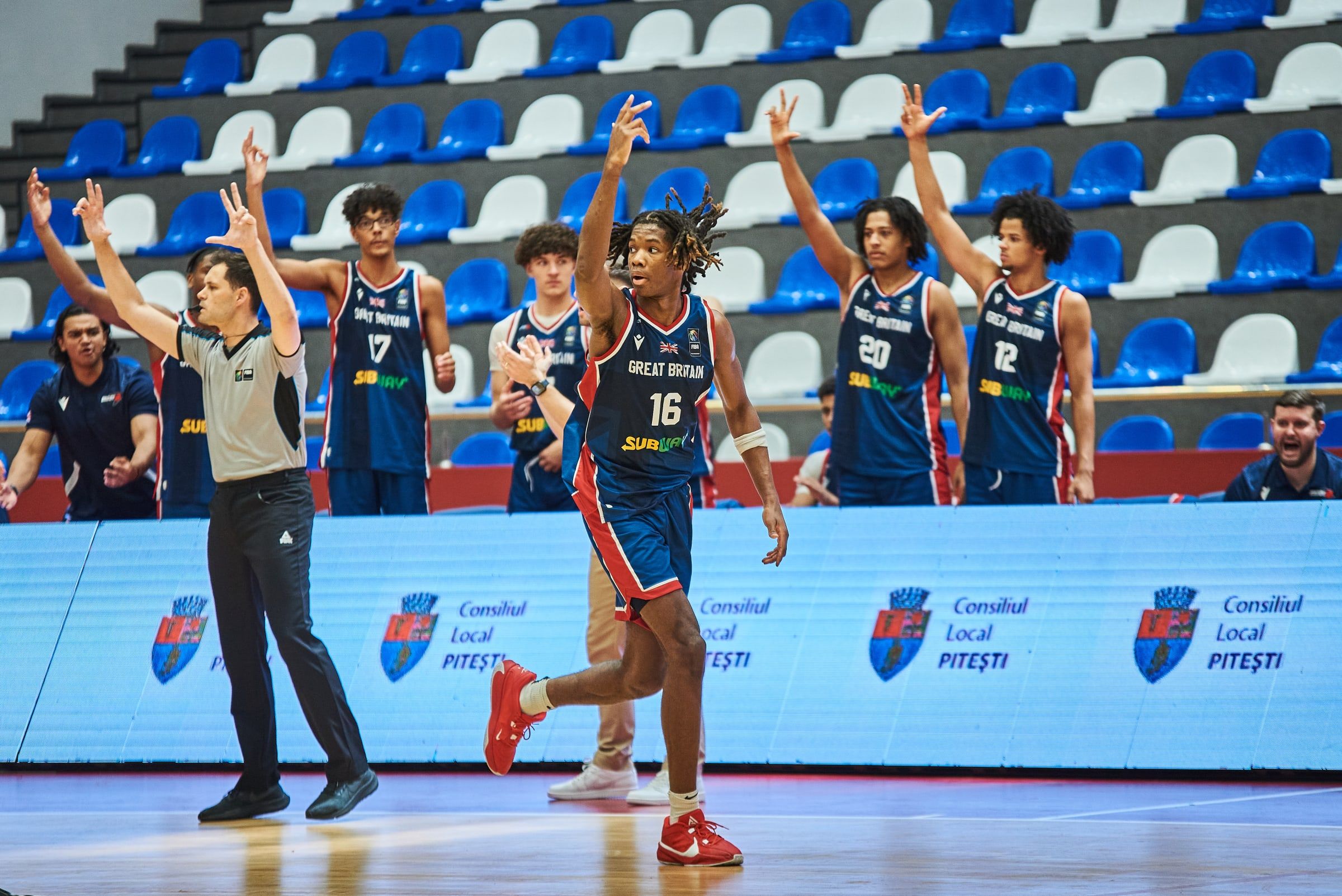 Ahamefule celebrates scoring a three against Ireland