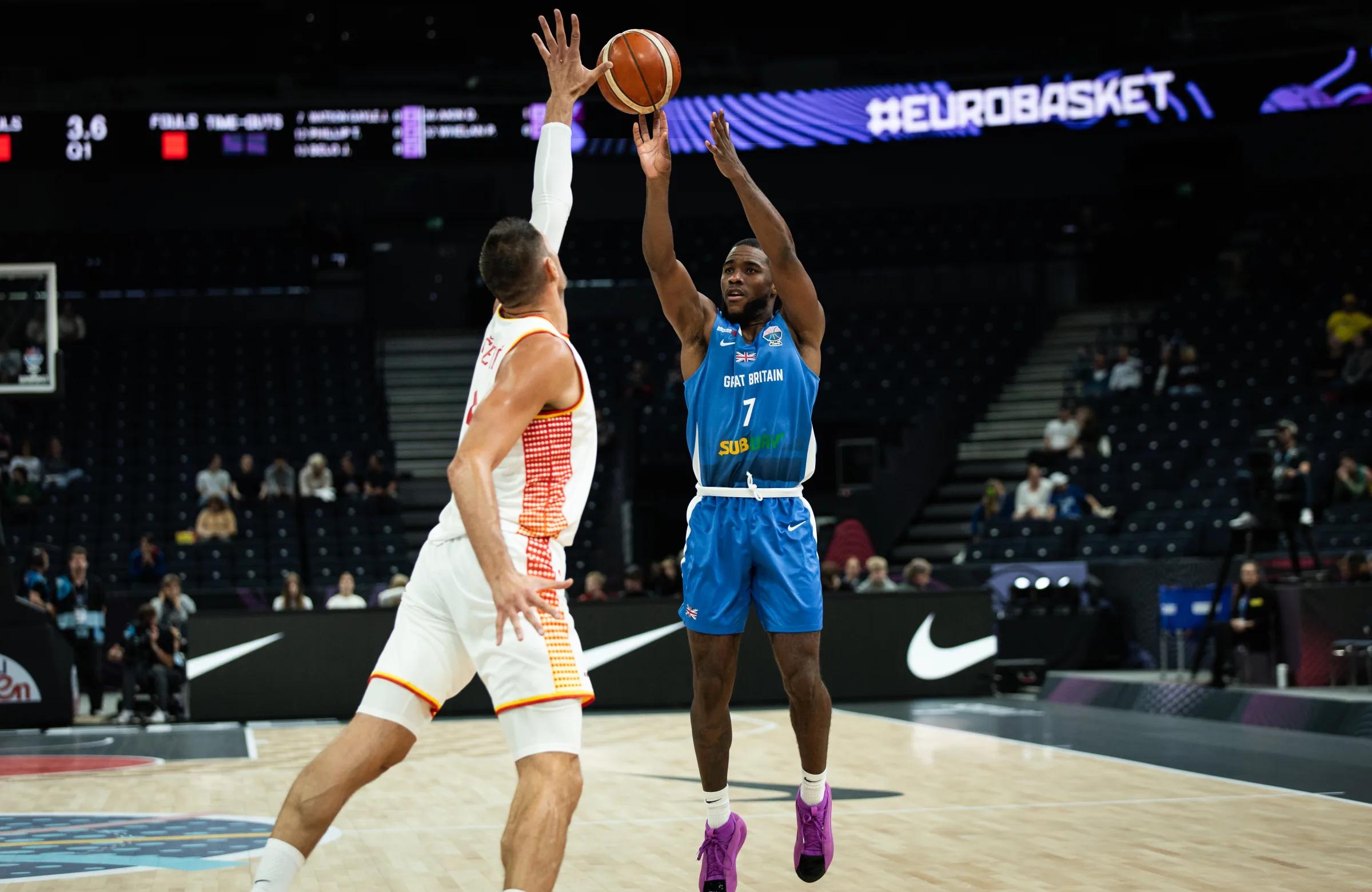 Watson-Gayle pulls up for three over Nikola Vucevic for GB against Montenegro at EuroBasket 2025