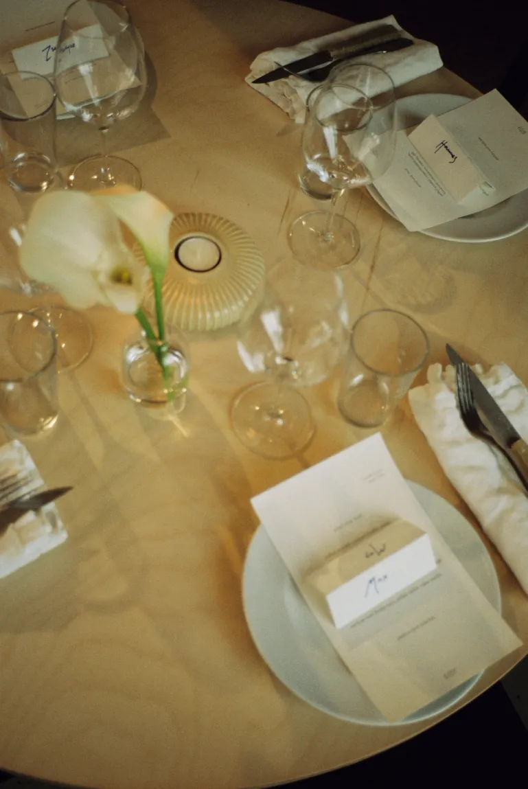 table setting with flowers and nameplace holders and a menu