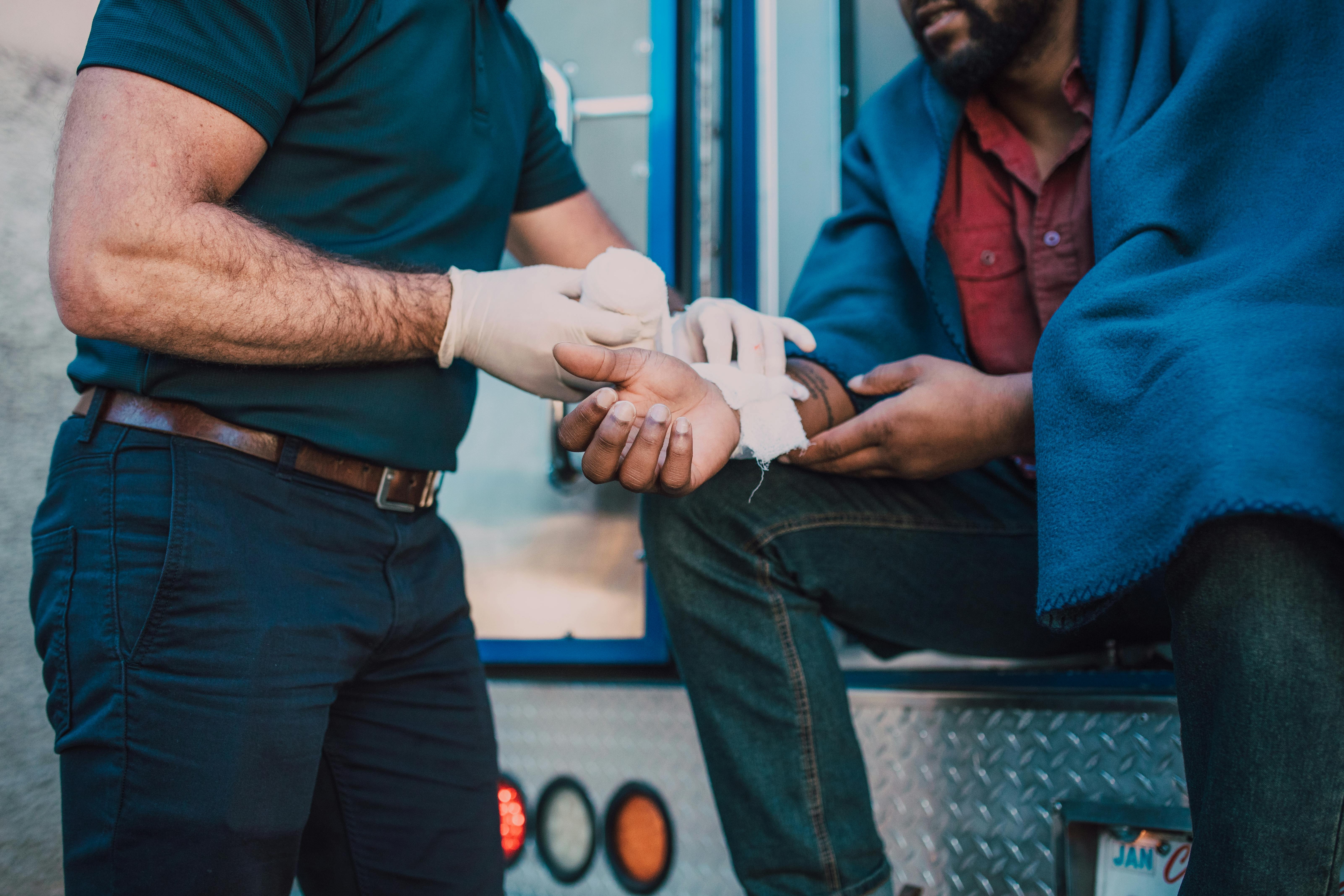 Image Man receiving medical treatment for hand injury after accident, illustrating personal injury claim risks in Maryland