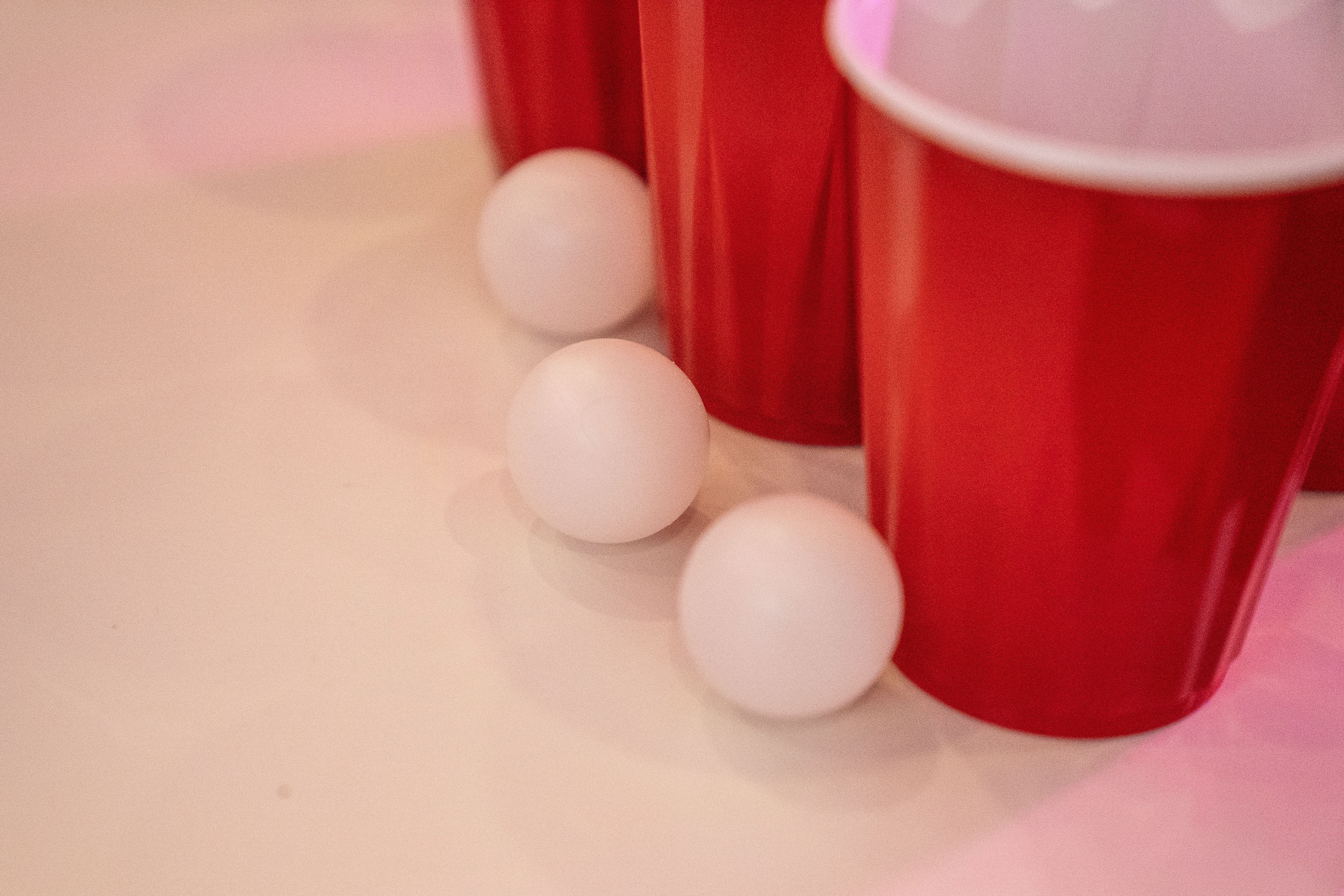 Red party cups and ping pong balls on a table after a college party, a common setting for an underage DUI in Maryland