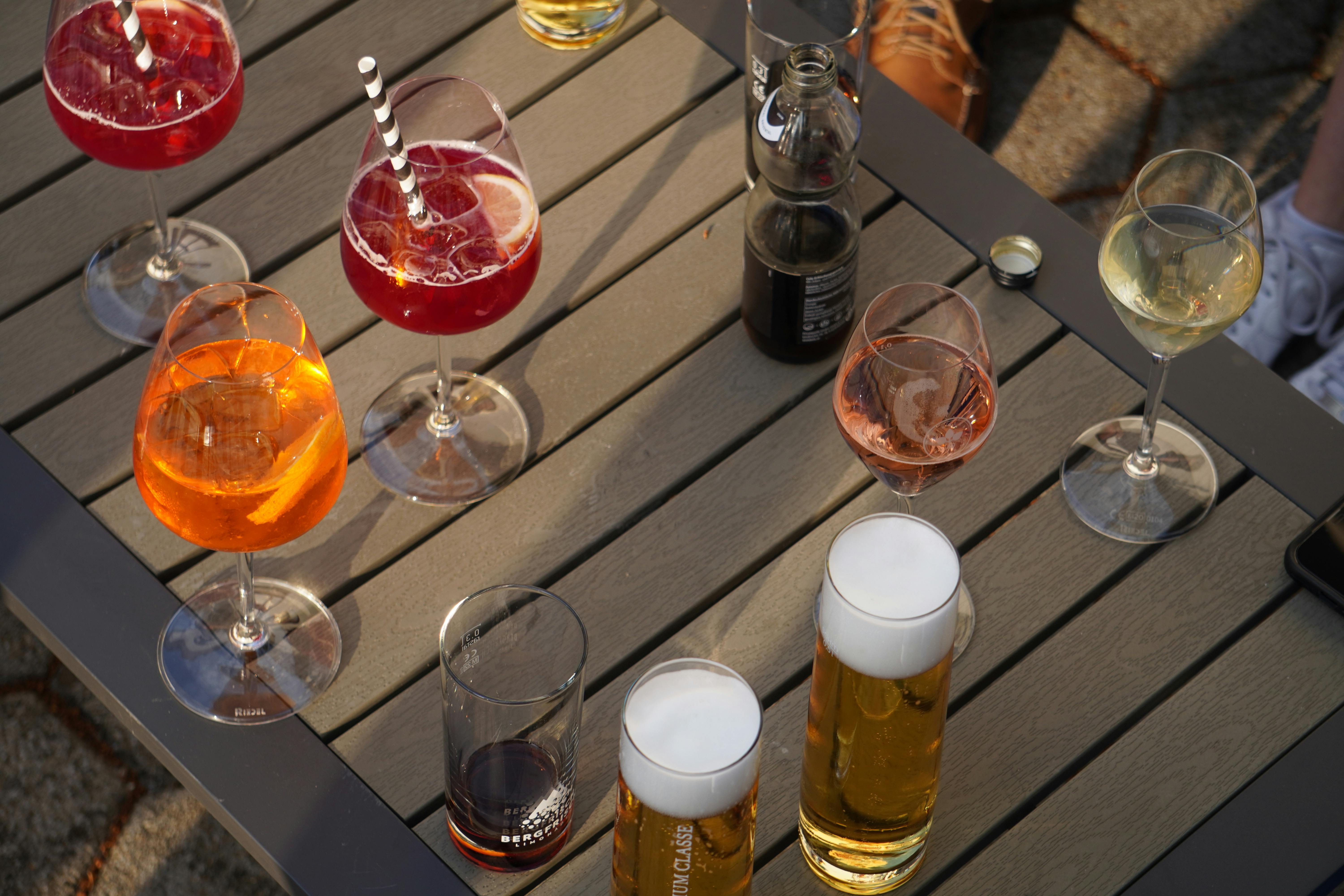 Alcoholic drinks on an outdoor table during a festival or social event, illustrating drinking before a potential DUI situation