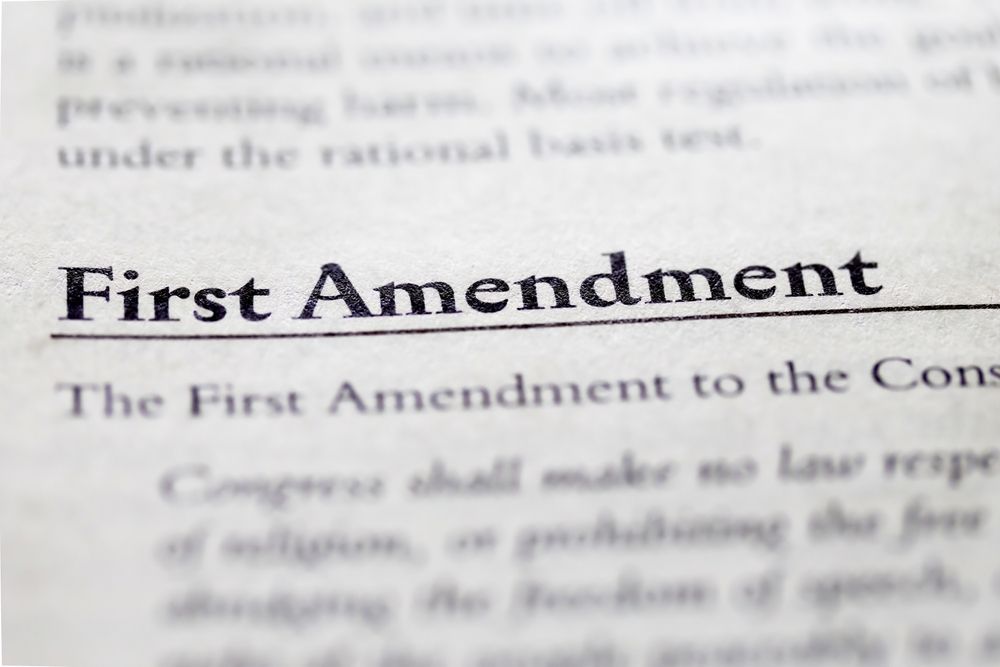 Close-up of the First Amendment text in a legal document, symbolizing constitutional rights and public filming laws in Maryland.