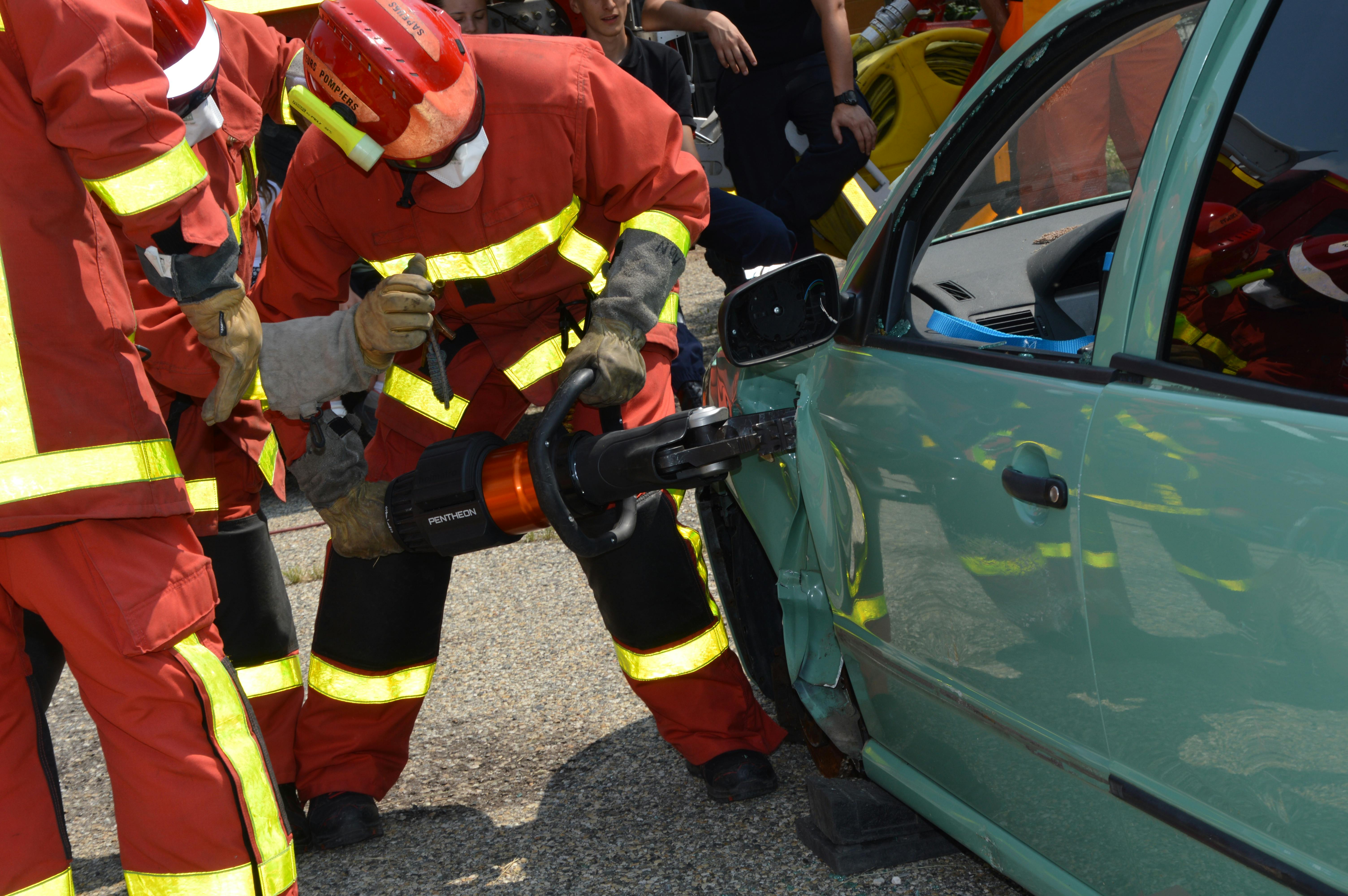 Emergency responders using rescue tools to free driver after Maryland car accident, illustrating post-crash response and injury risks