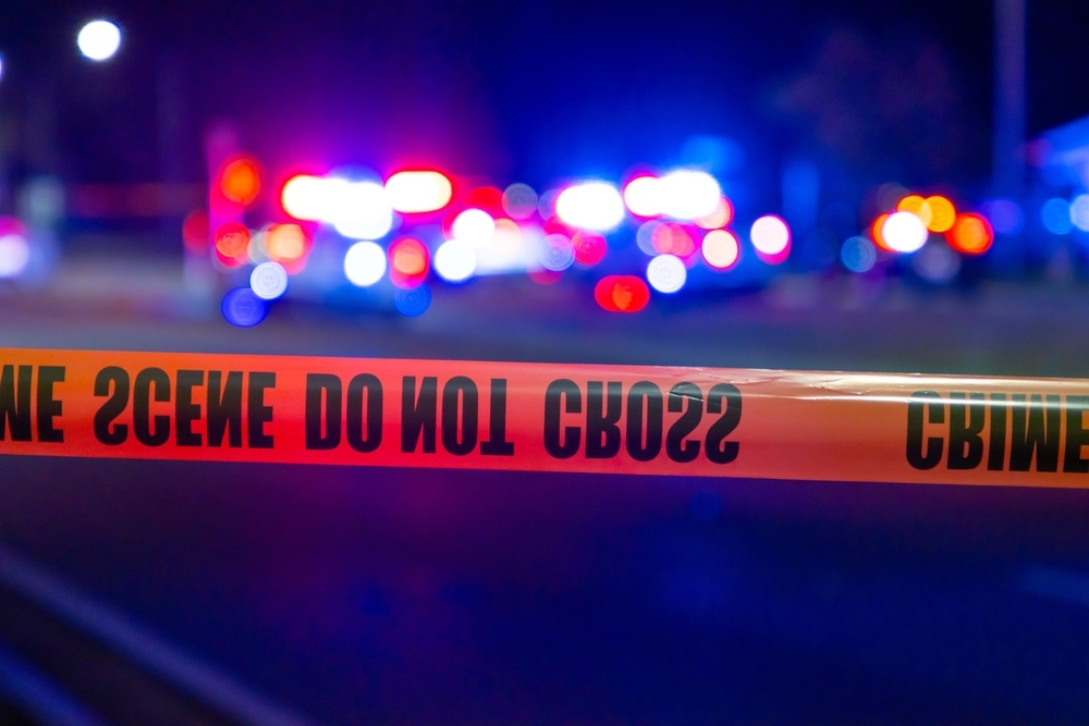 Image Crime scene tape with blurred police lights in the background, representing an ongoing Maryland crash investigation.