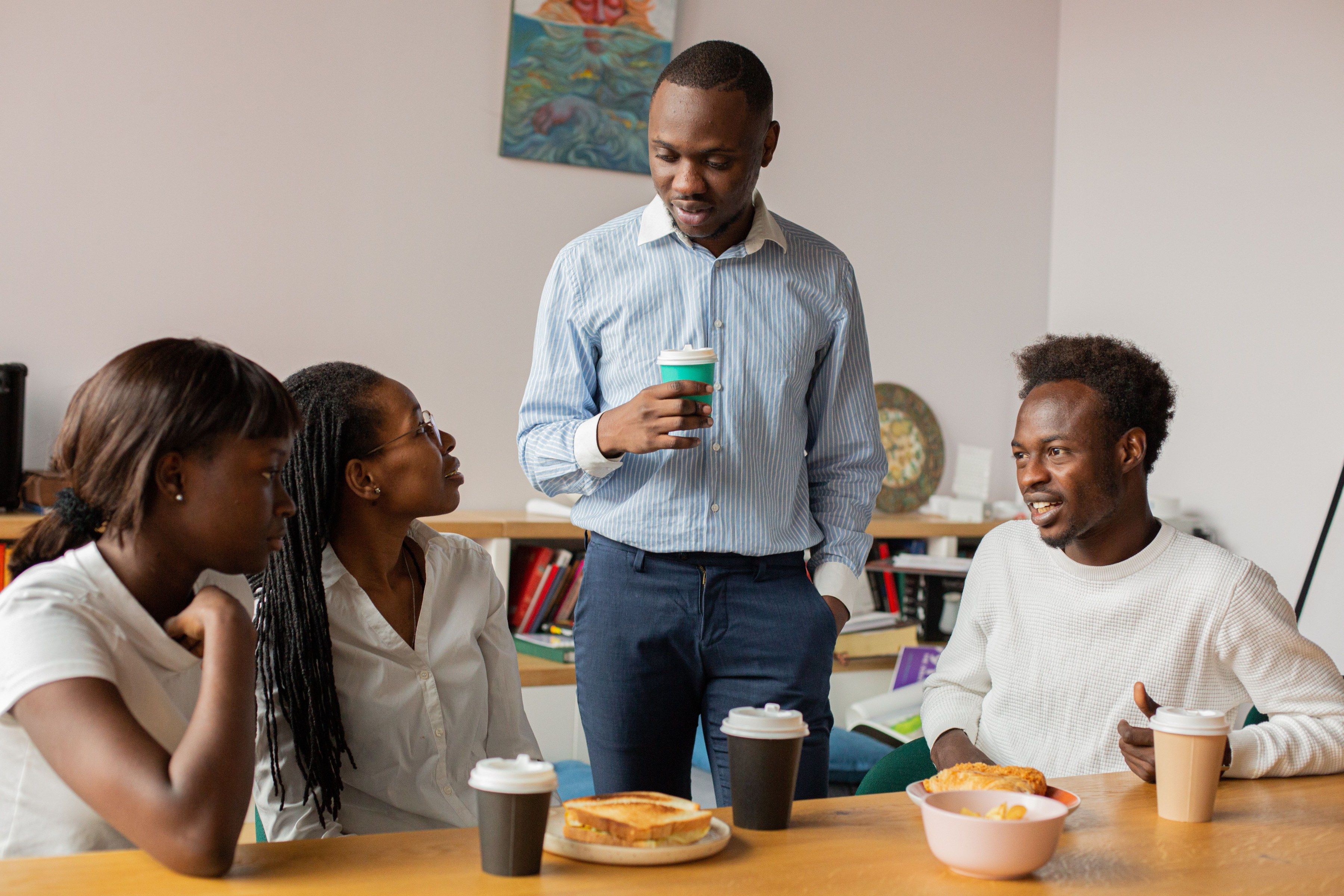 Colleagues talking over coffee at a team break.