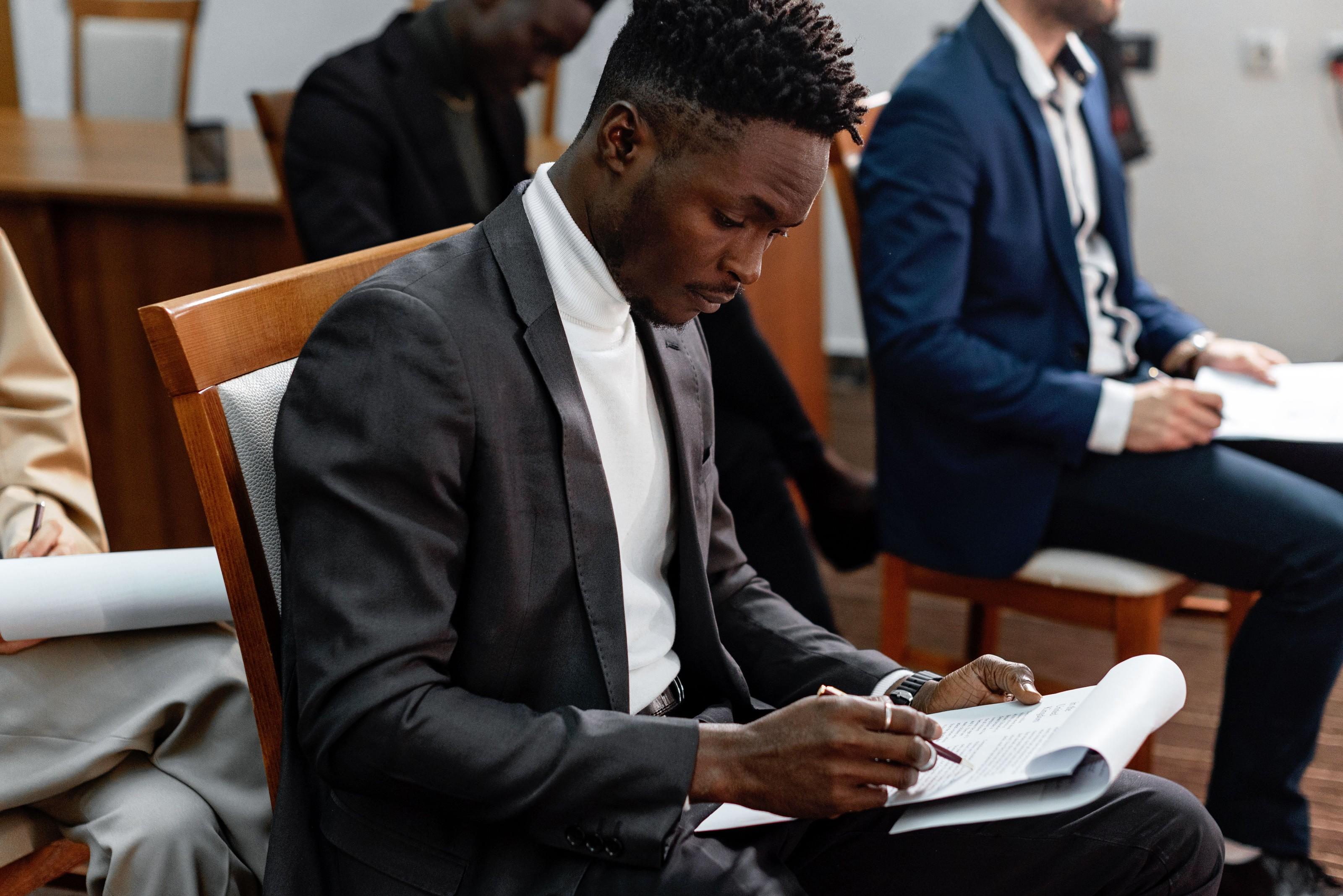 A team member marking up a document during a closing meeting.