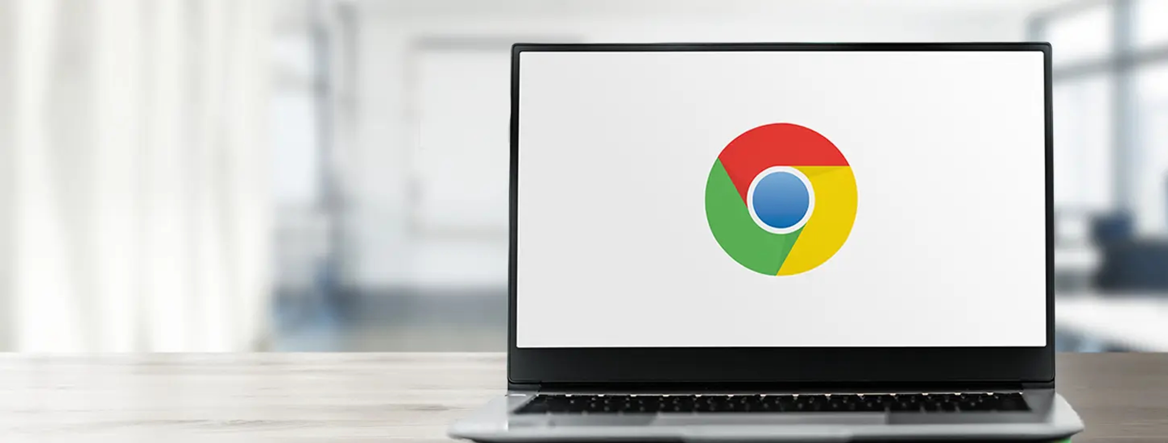 A hero graphic showing a laptop with the Google Chrome logo