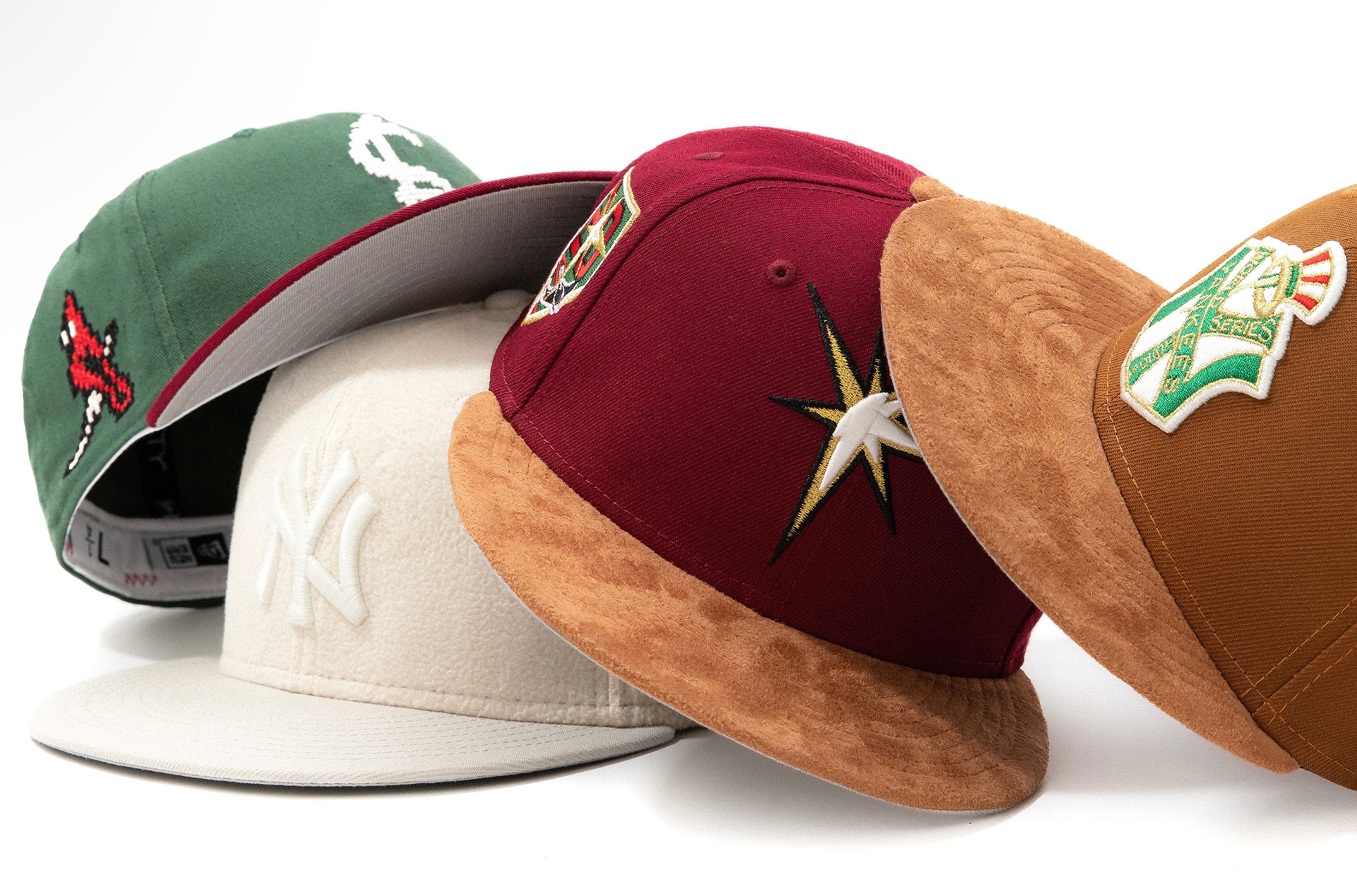Four baseball caps with various team logos embroidered on the front