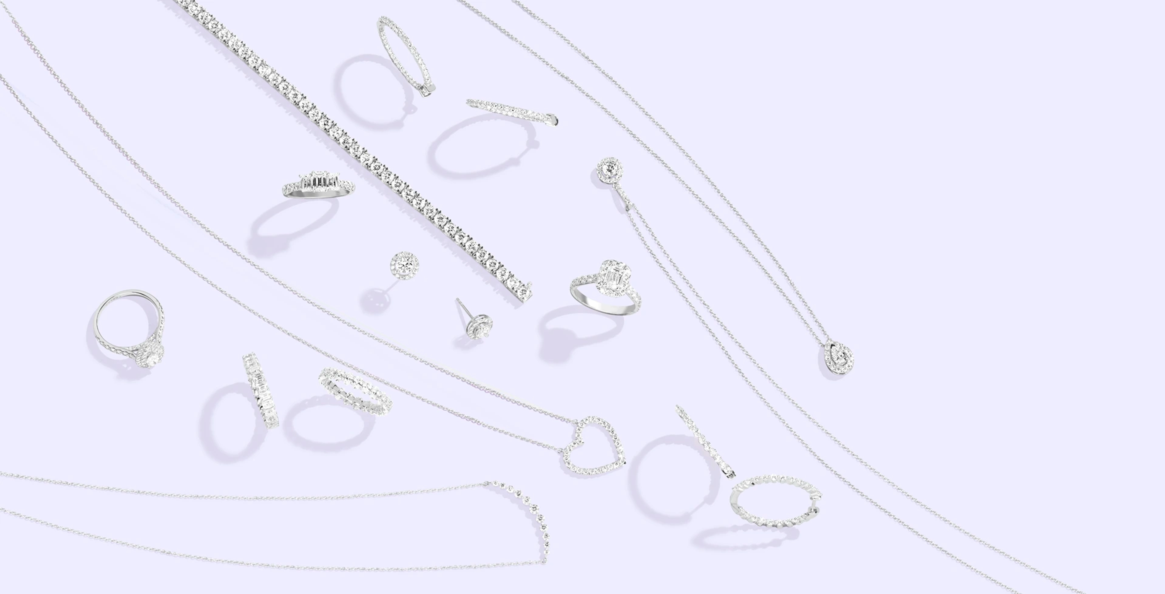 Diamond necklaces, rings, and earrings from Verlas on a light purple surface.