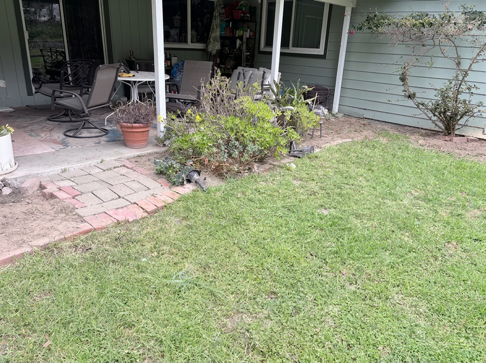 Backyard paver patio and landscape design with lush greenery in Watsonville, CA