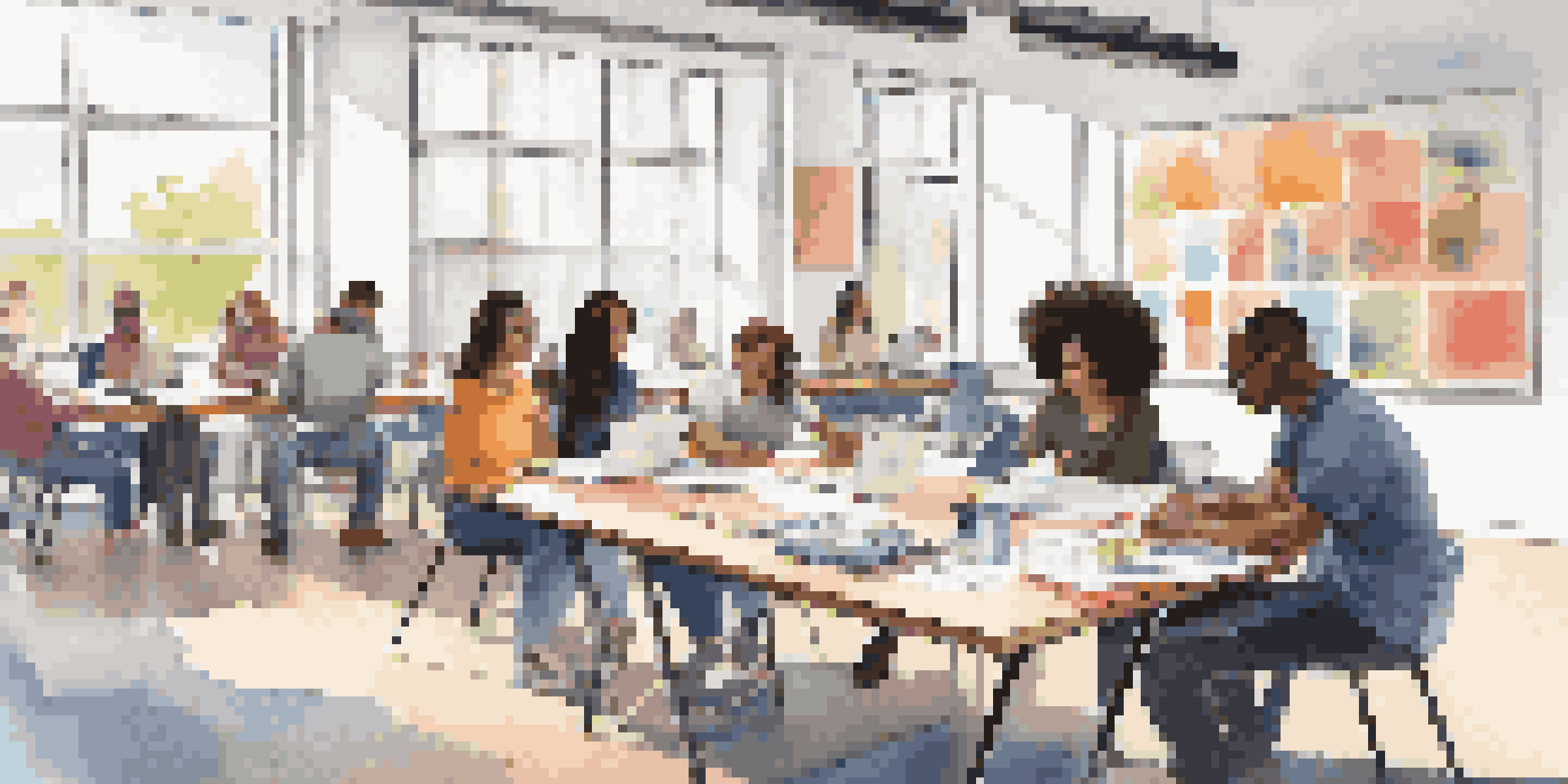 A group of diverse students working together on a project in a bright study area.
