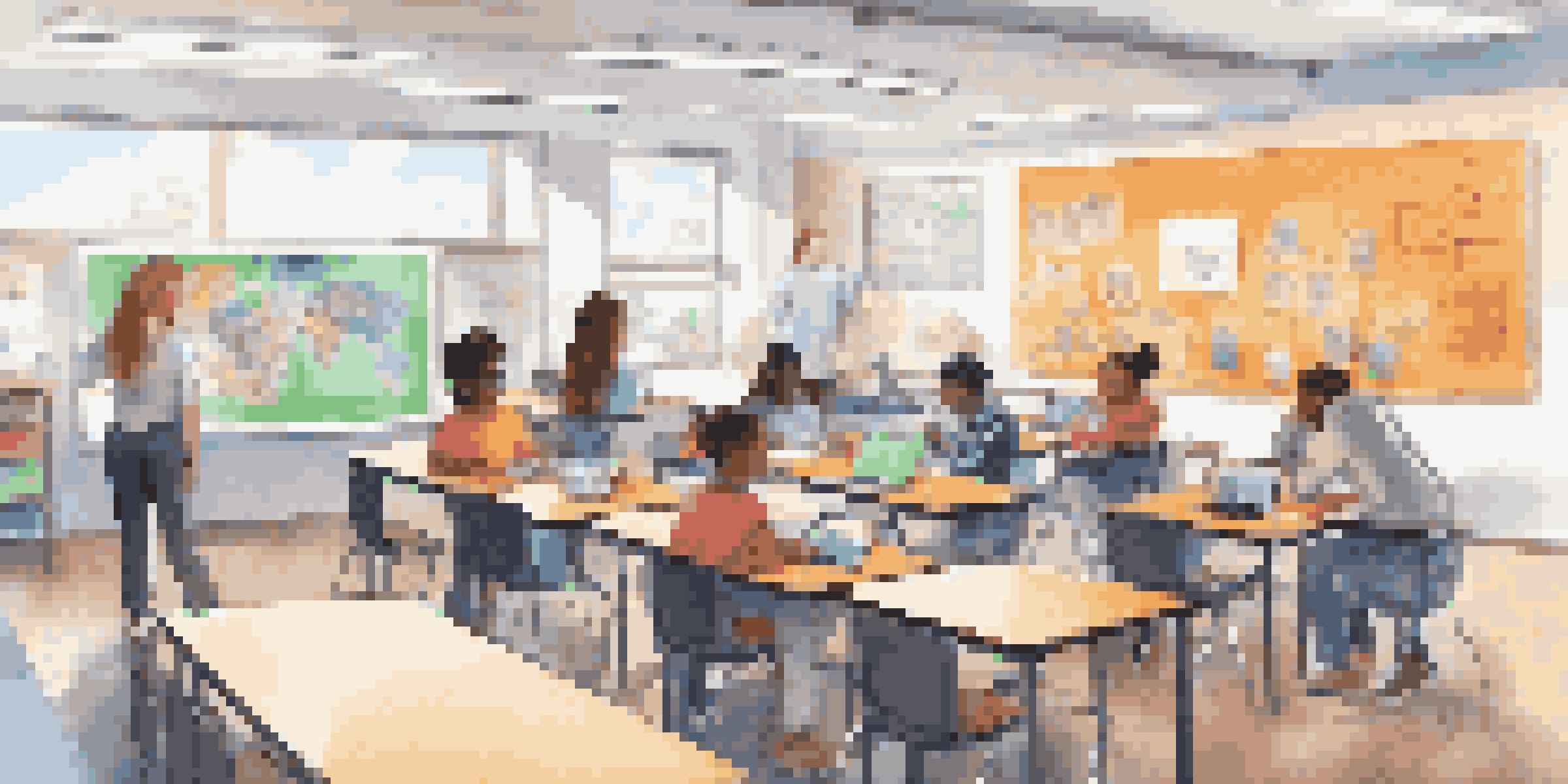 A diverse group of students working together in a modern classroom, using technology for learning.