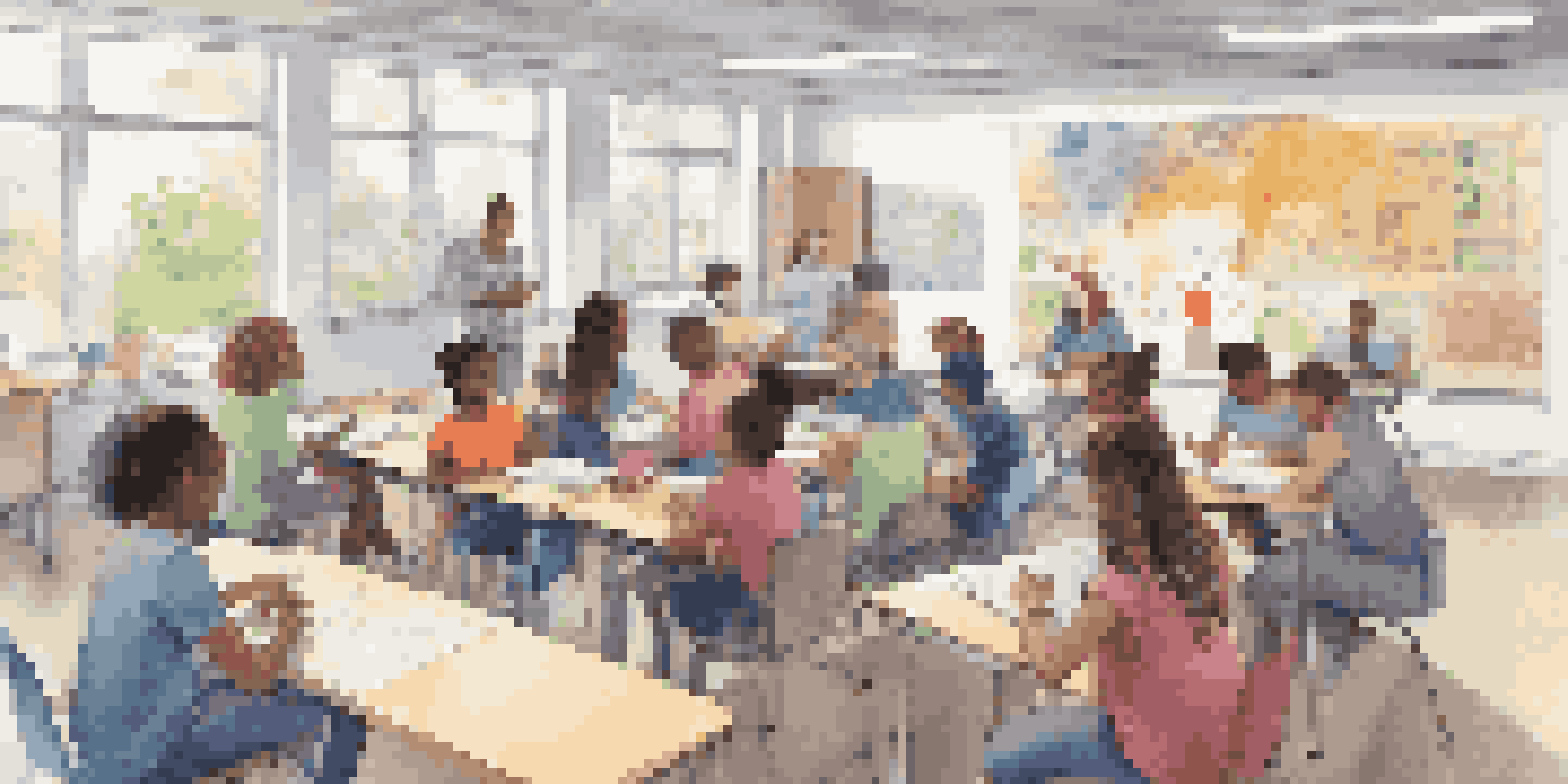 A bright and colorful classroom filled with students of diverse backgrounds collaborating and discussing ideas. The room has educational posters and a whiteboard in the background.