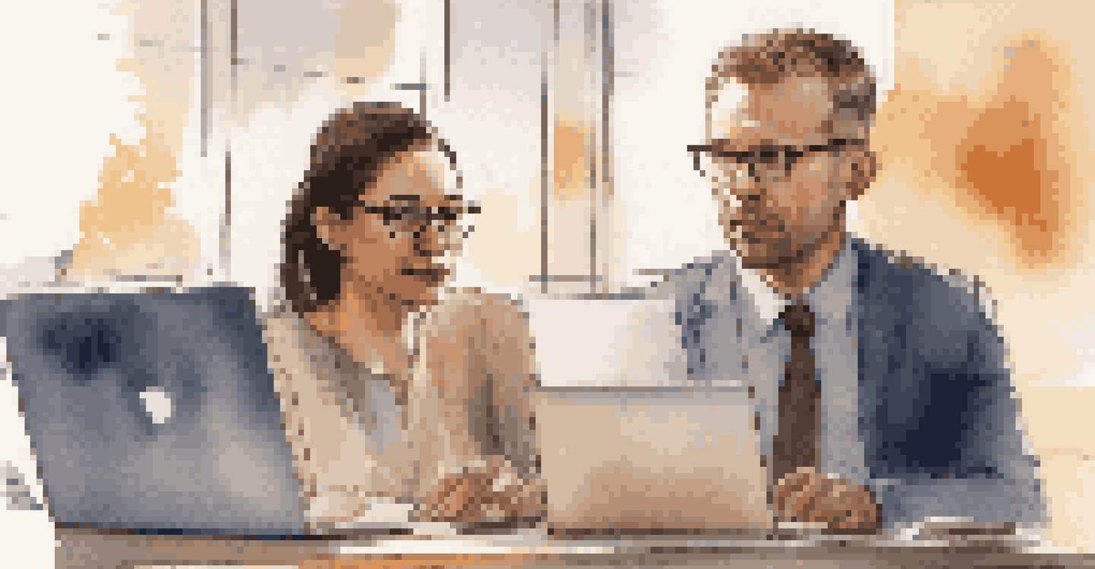 Two professionals in a close-up discussion, one pointing at a laptop screen while the other listens, in a cozy office environment.