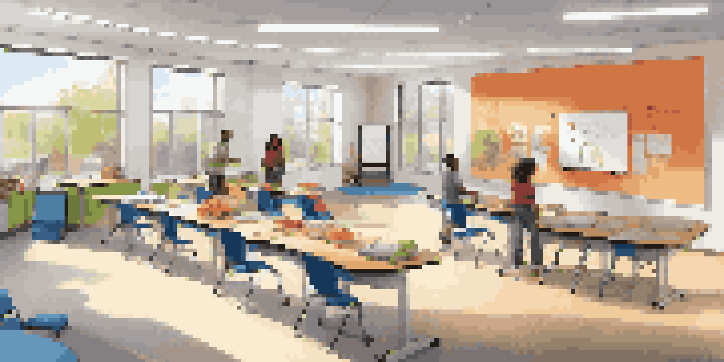 A bright, modern classroom with movable desks, colorful bean bags, and an interactive whiteboard, where diverse students are engaging in group discussions.