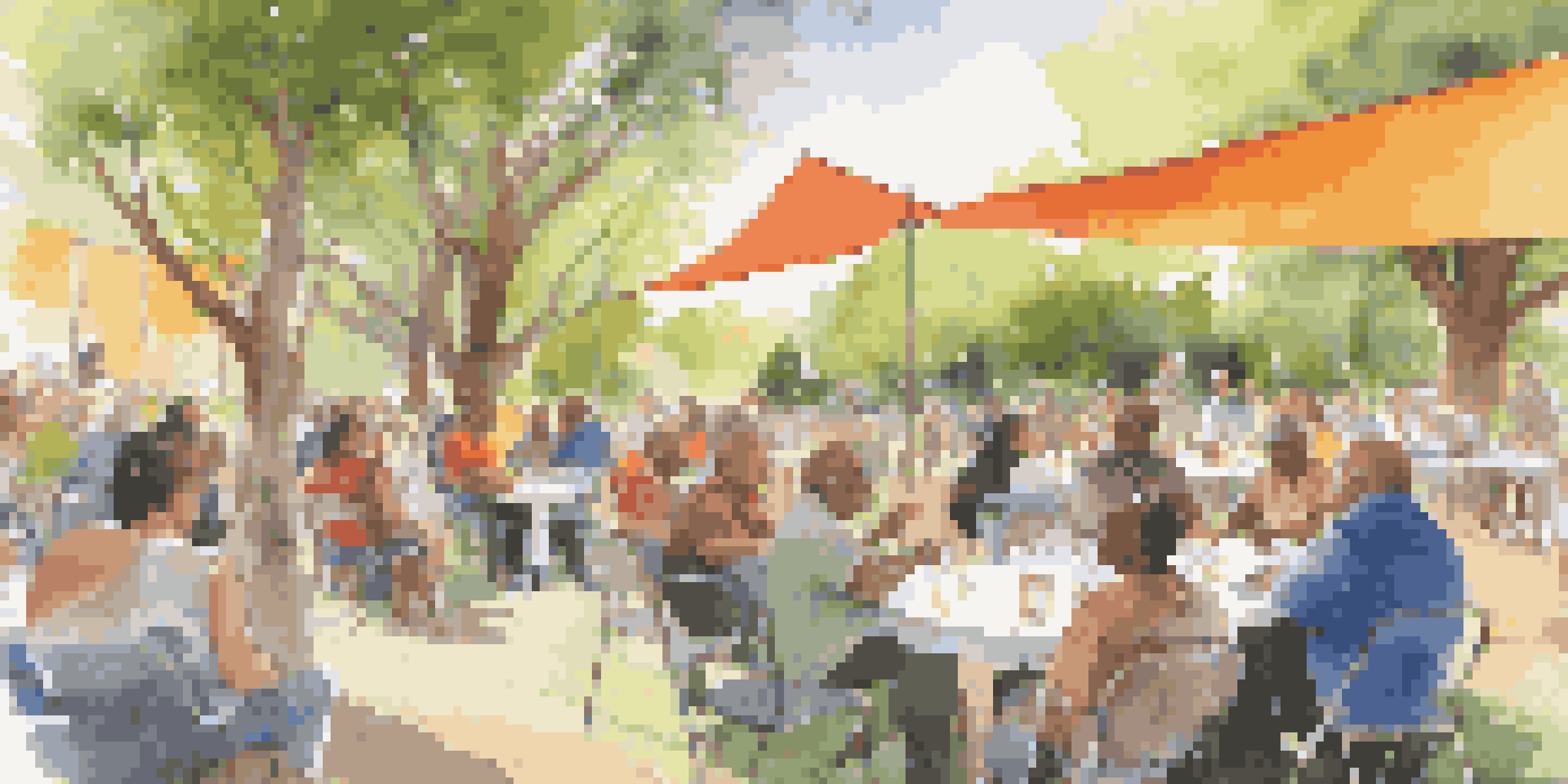 A diverse group of people engaged in a lively discussion at a community forum, surrounded by greenery and colorful banners.
