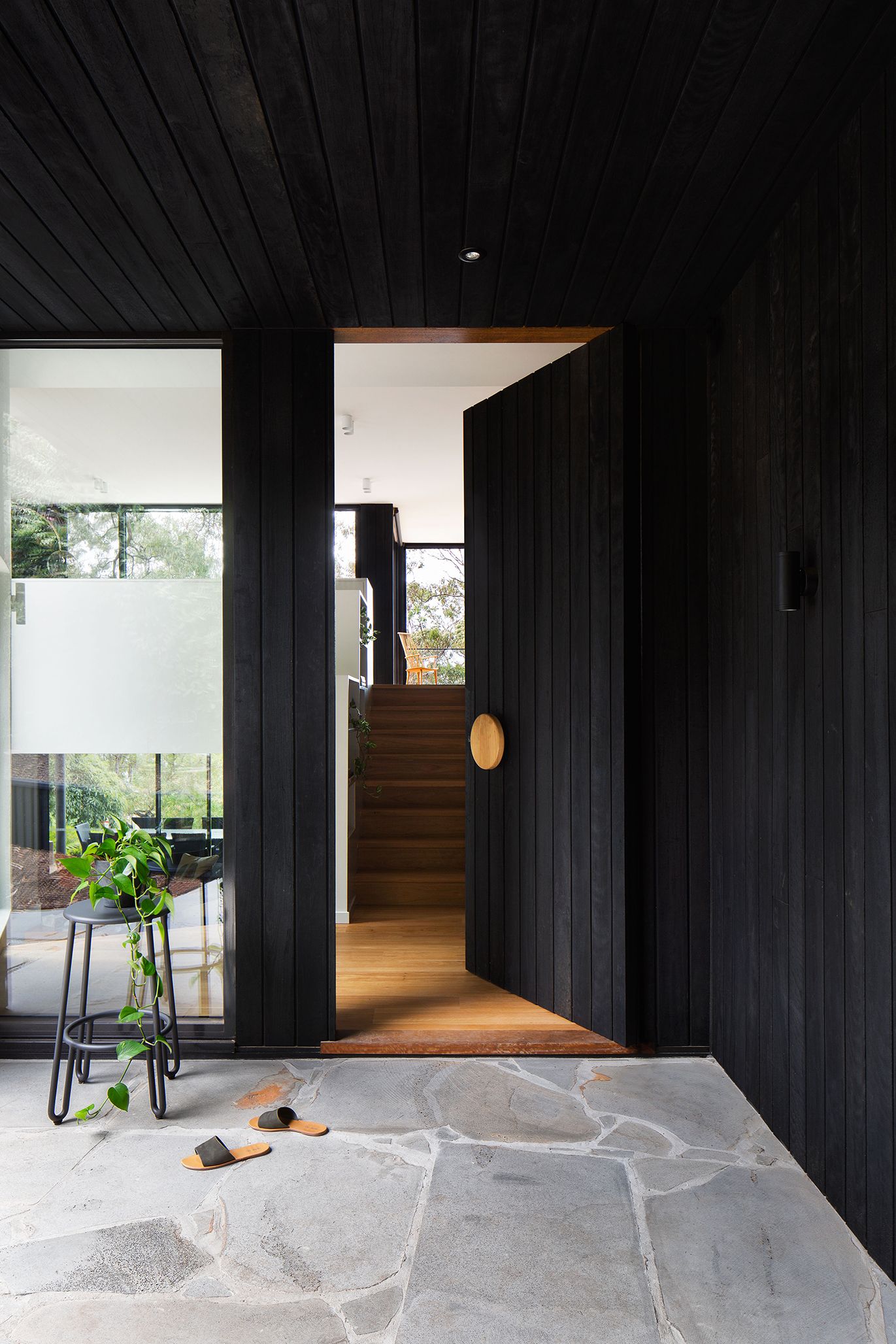 image of Lorne Beach House - charred timber pivot door 