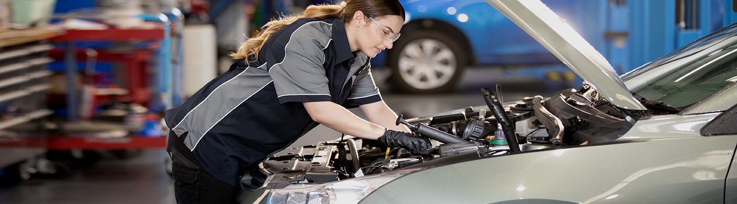 Mechanic looking under bonnet of a car
