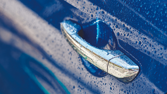 Water beading on a car door