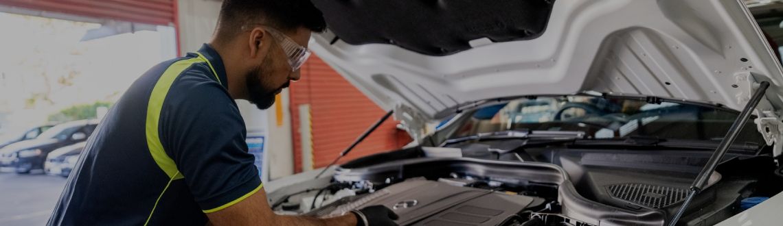 mechanic checking vehicle on iPad